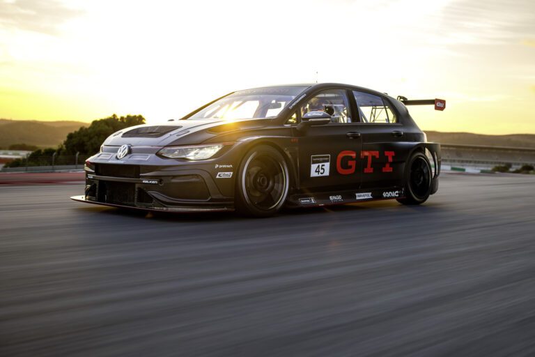 Front three quarters view of a Volkswagen Golf GTI Clubsport 24h in motion on a racetrack.