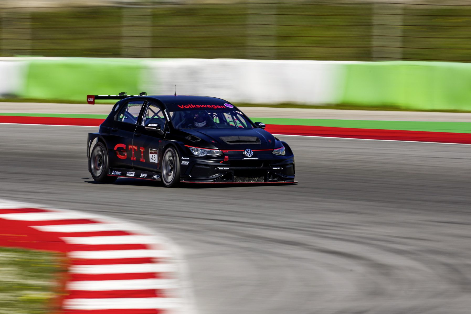 Front three quarters view of a 2025 Volkswagen Golf GTI Clubsport 24h on a racetrack.