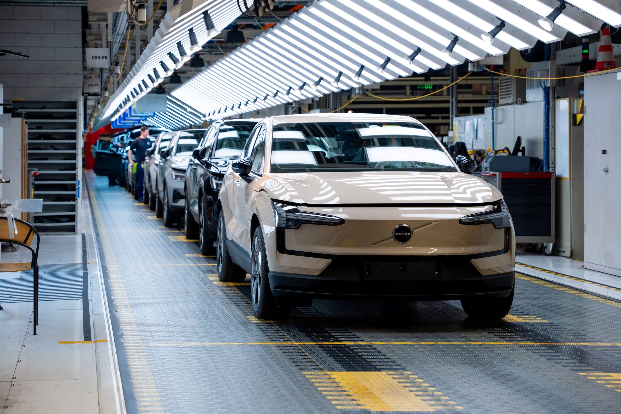 A photo of a champagne coloured Volvo EX30 on the production line at Volvo Cars plant in Ghent, Belgium.