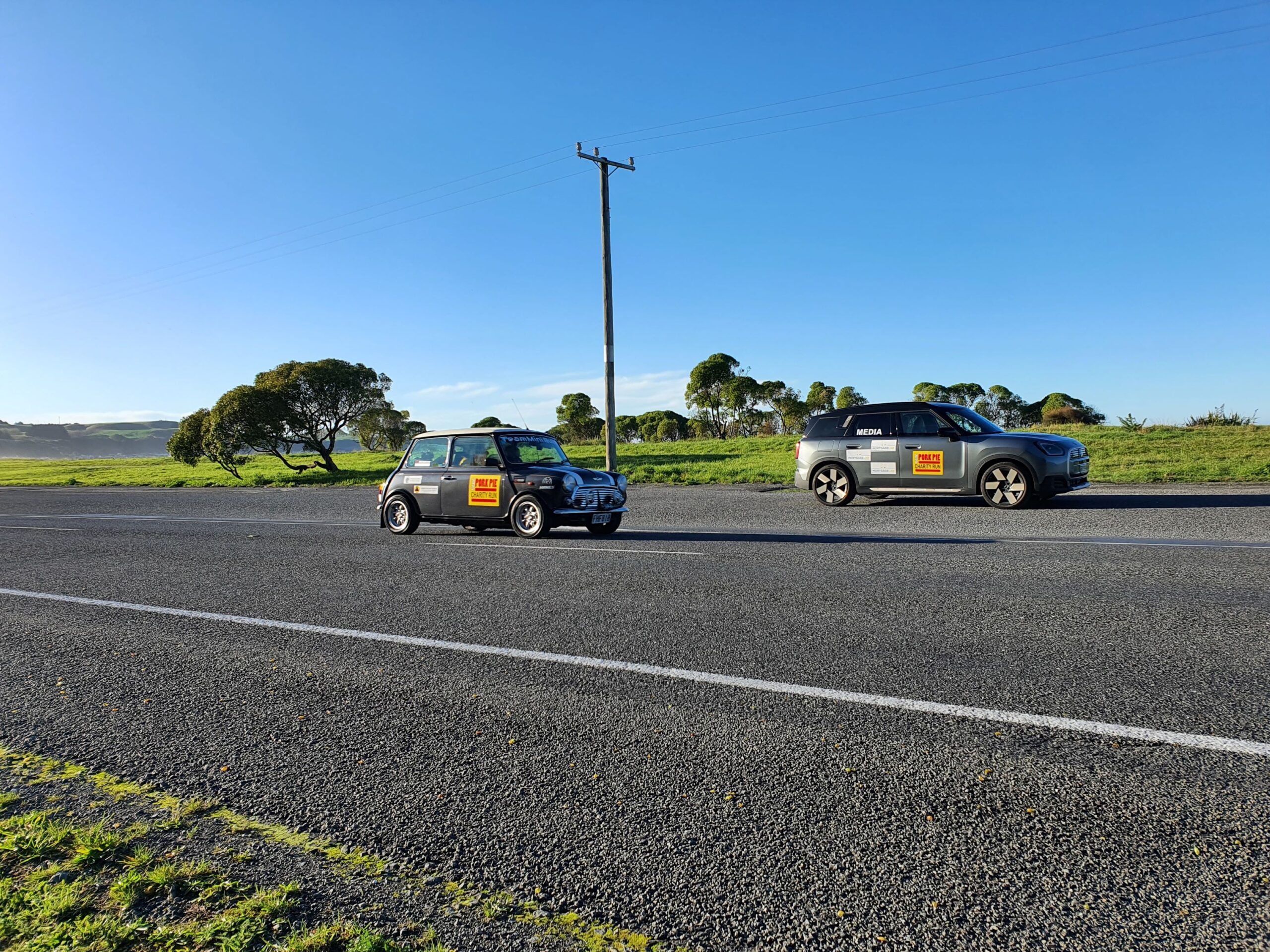 The classic Mini of team 'Mini Bull' passing our Employee Lab branded 2025 Mini Countryman SE in the background on the 2025 Pork Pie Charity Run.