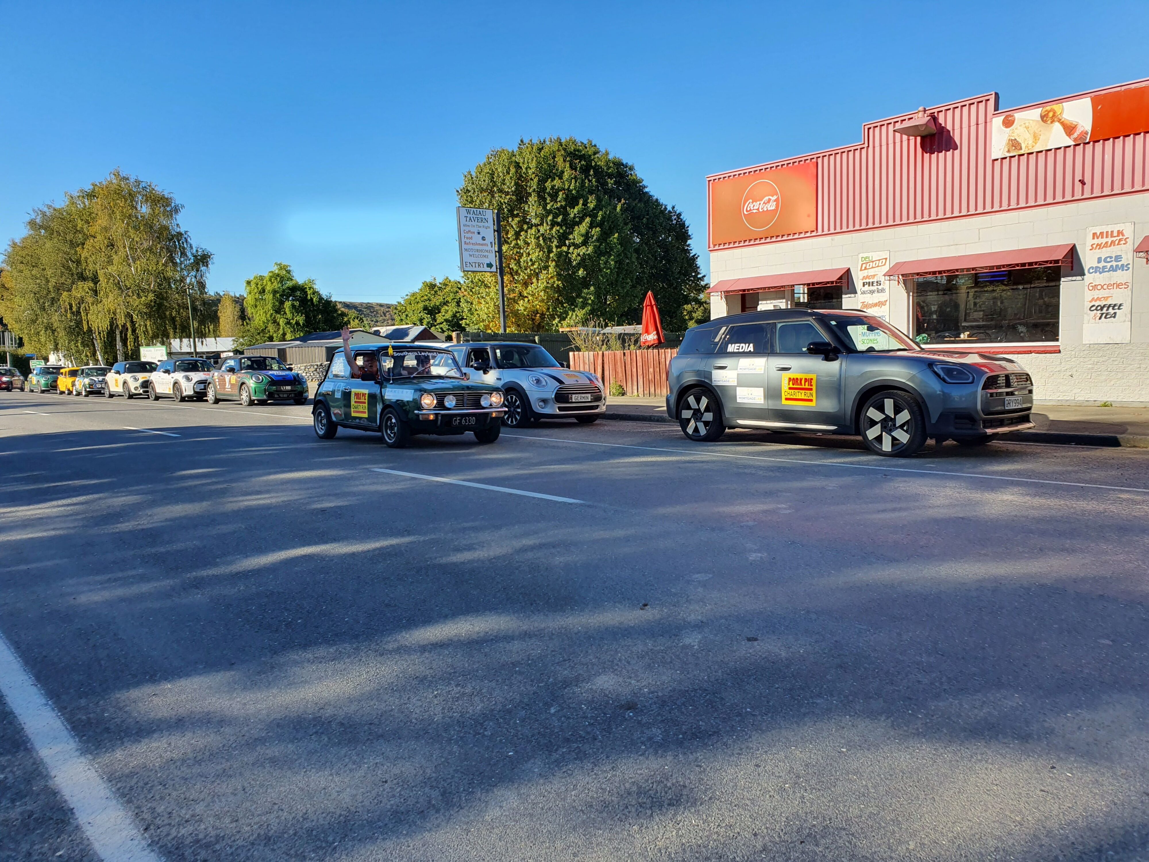 Team 'Southern Leyland Lads' pass the group of Minis and our Mortgage Lab branded 2025 Mini Countryman SE outside Waiau on the 2025 Pork Pie Charity Run.