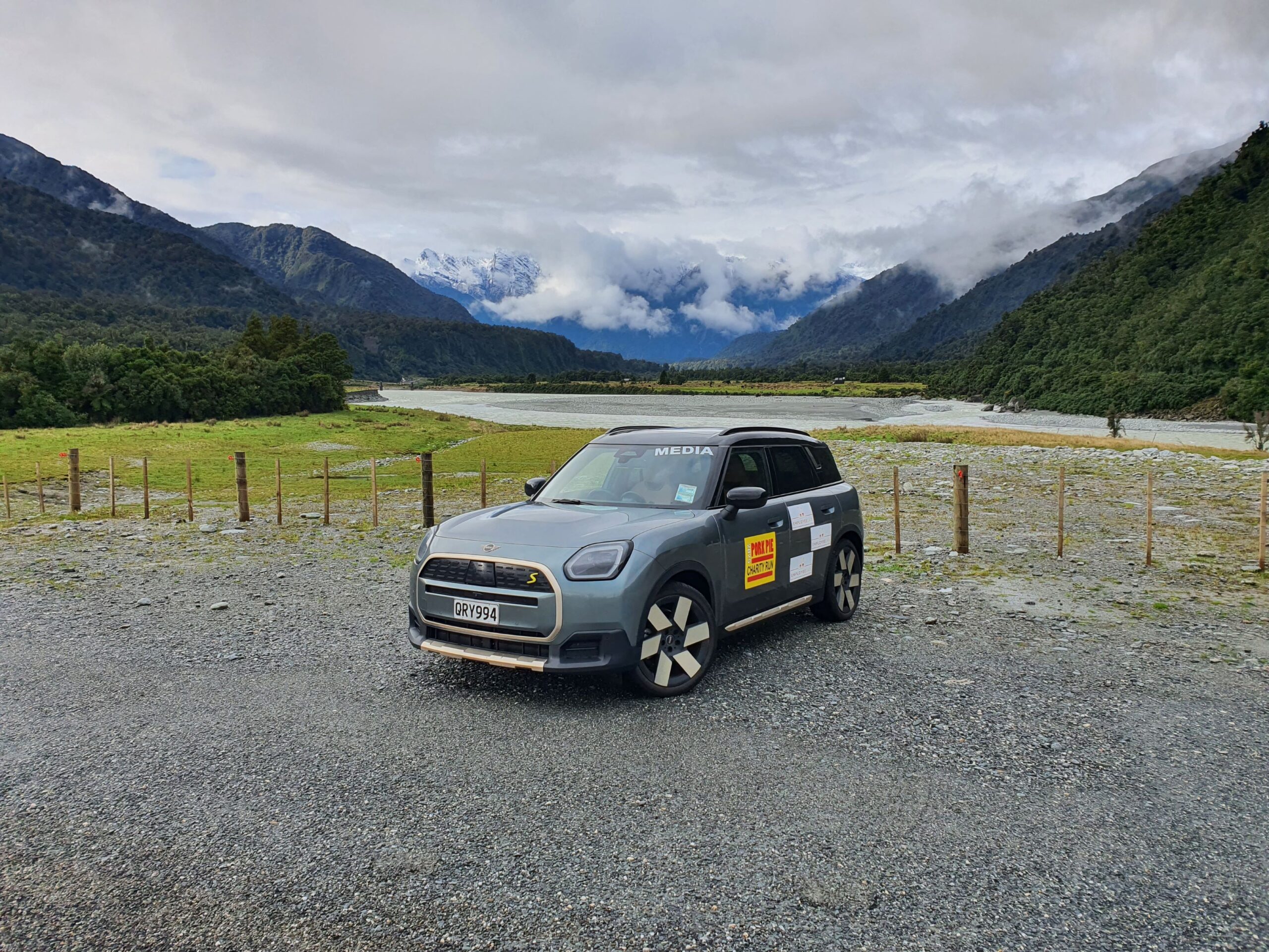 Front three quarters view of a 2025 Mini Countryman SE All4 with Employee Lab branding and the Southern Alps in the background on the 2025 Pork Pie Charity Run.