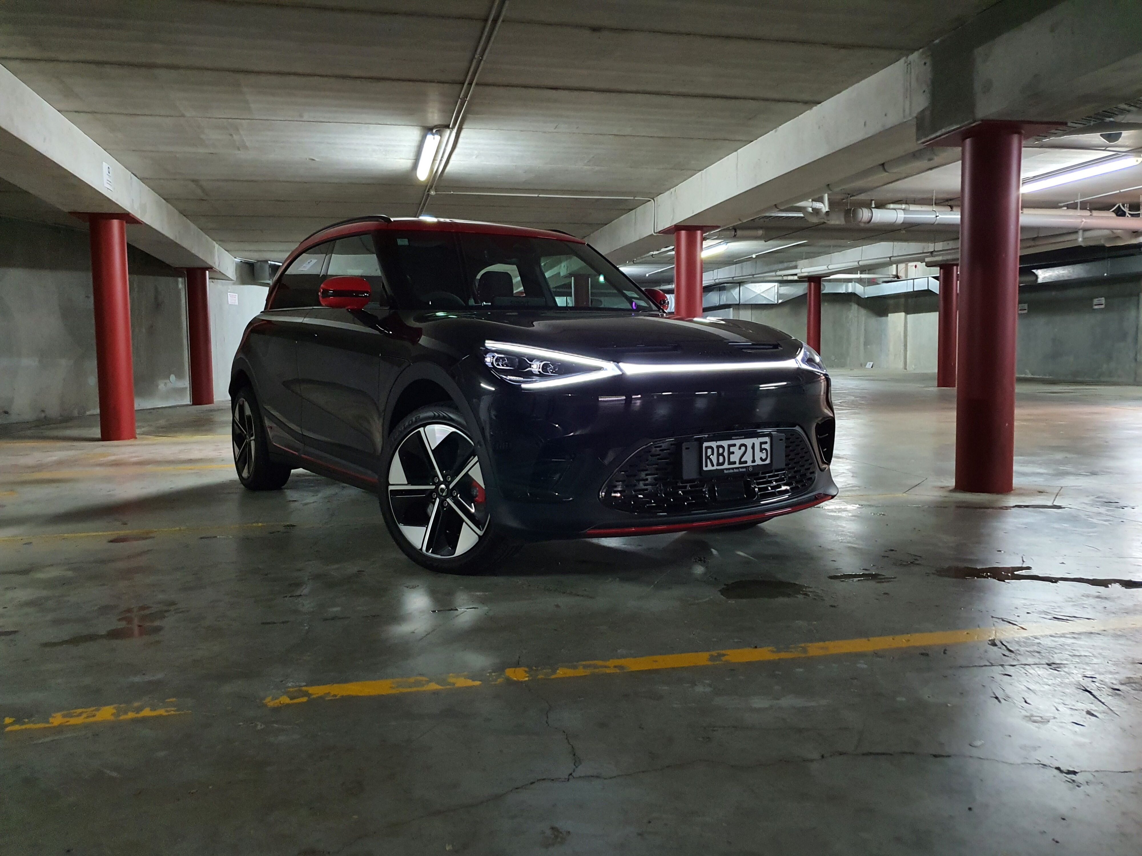Front three quarters view of a 2025 smart #1 Brabus in black with a red roof.