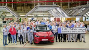 The one millionth Volkswagen Group EV, a red ID.3 GTX pictured in the Zwickau plant in front of the production team.