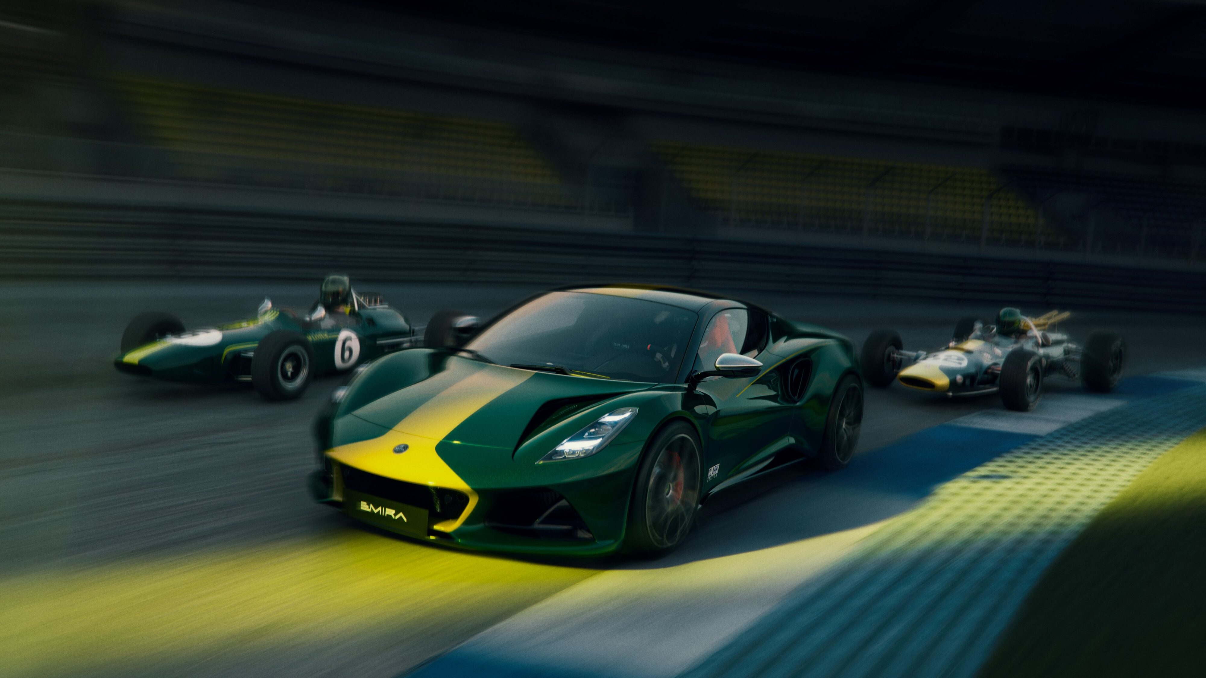 A photo of a Lotus Emira Clark Edition flanked by two Jim Clark Lotus F1 cars.