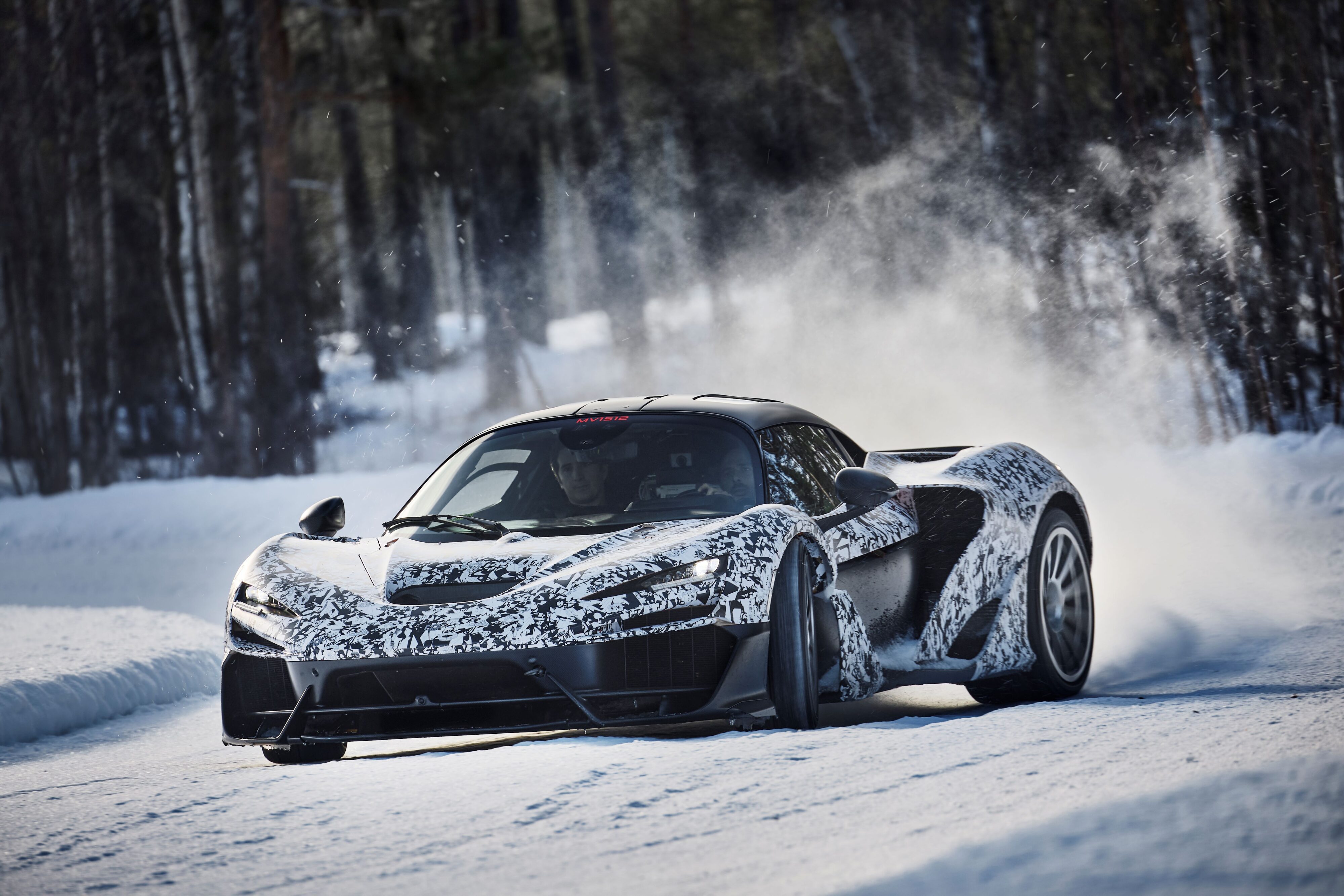 A camouflaged McLaren W1 goes sideways during its cold weather testing.