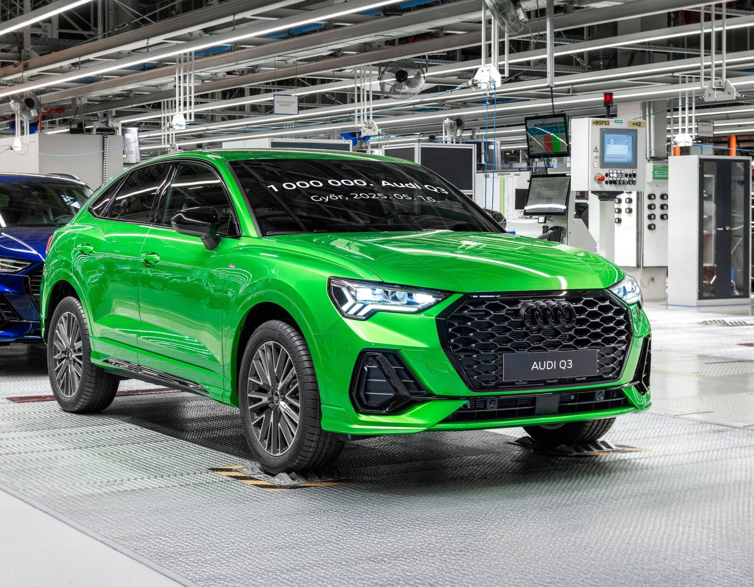 Front three quarters view of the one millionth Audi Q3 produced at the Gyor plant in Hungary. The car is painted in bright green.