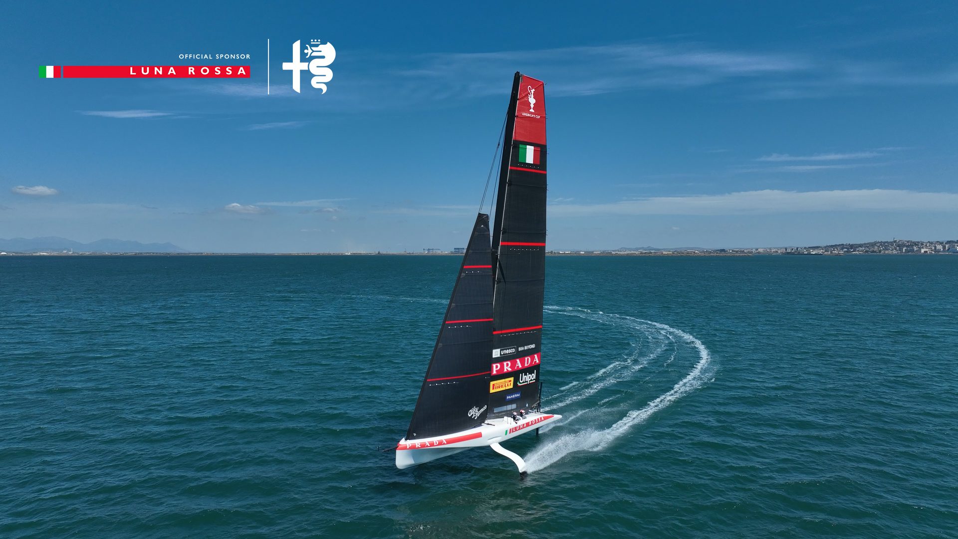 A photo of Prada Luna Rossa with Alfa Romeo branding on the sails.