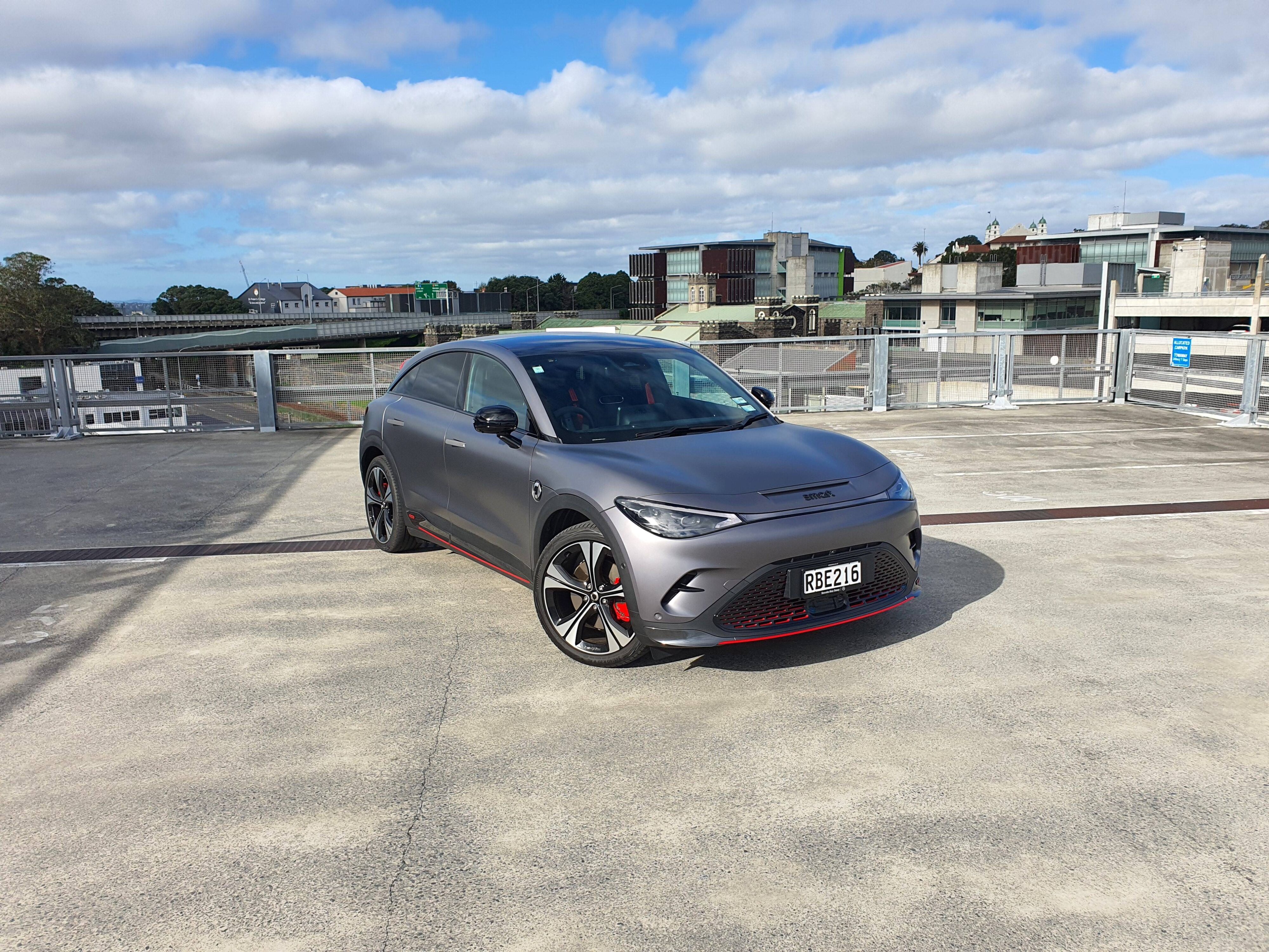 Front three quarters view of a matte grey 2025 smart #3 Brabus photographed atop a parking building in Auckland.