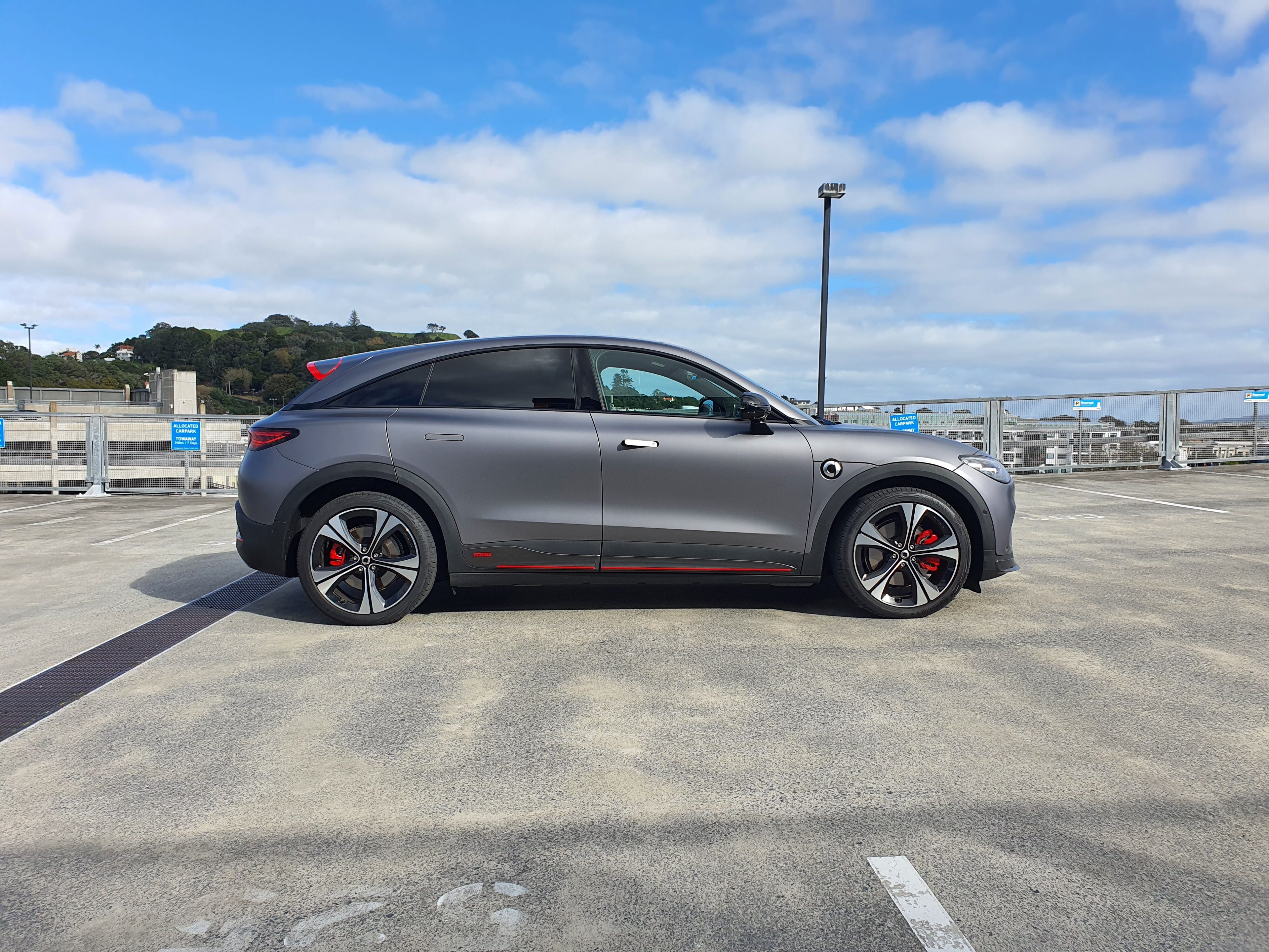 Side on view of a matte grey 2025 smart #3 Brabus photographed atop a parking building in Auckland.