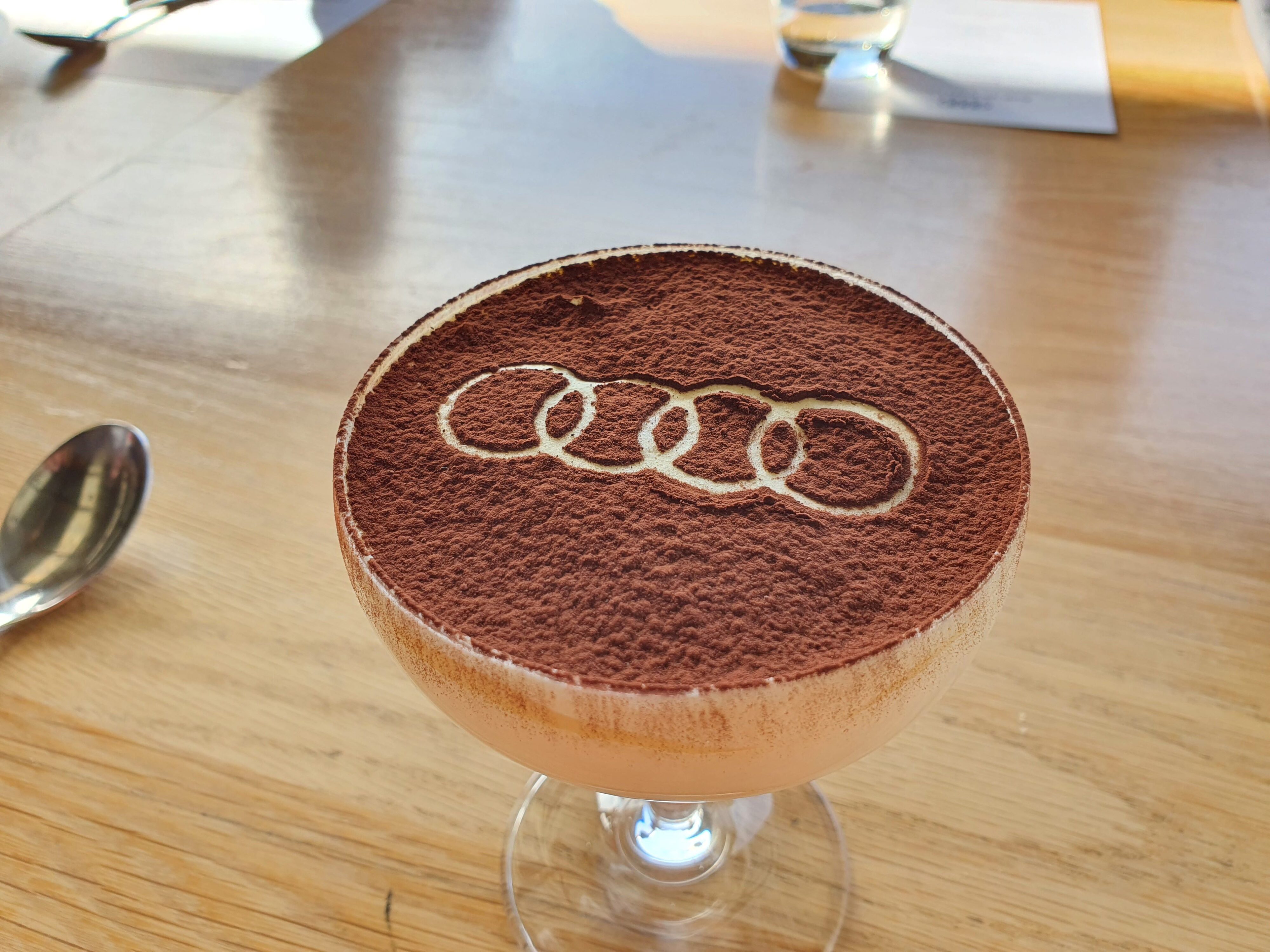 A photo of a cup of tiramisu with the Audi logo, created by Kauri Bay for the launch of the 2025 Audi Q5 and SQ5 New Zealand launch.