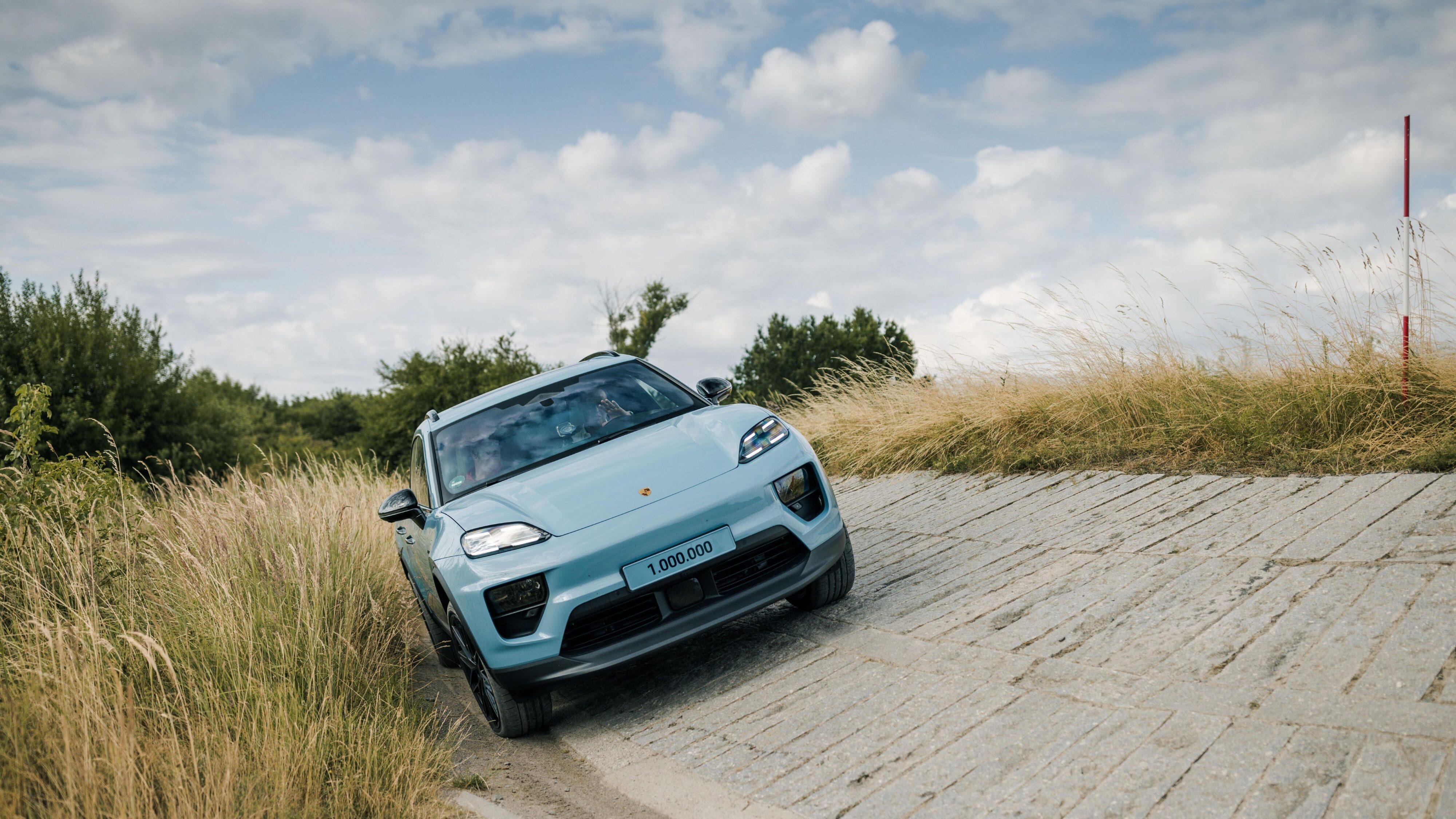 Front on view of a light blue Porsche Macan 4S, the one millionth Macan to be produced.