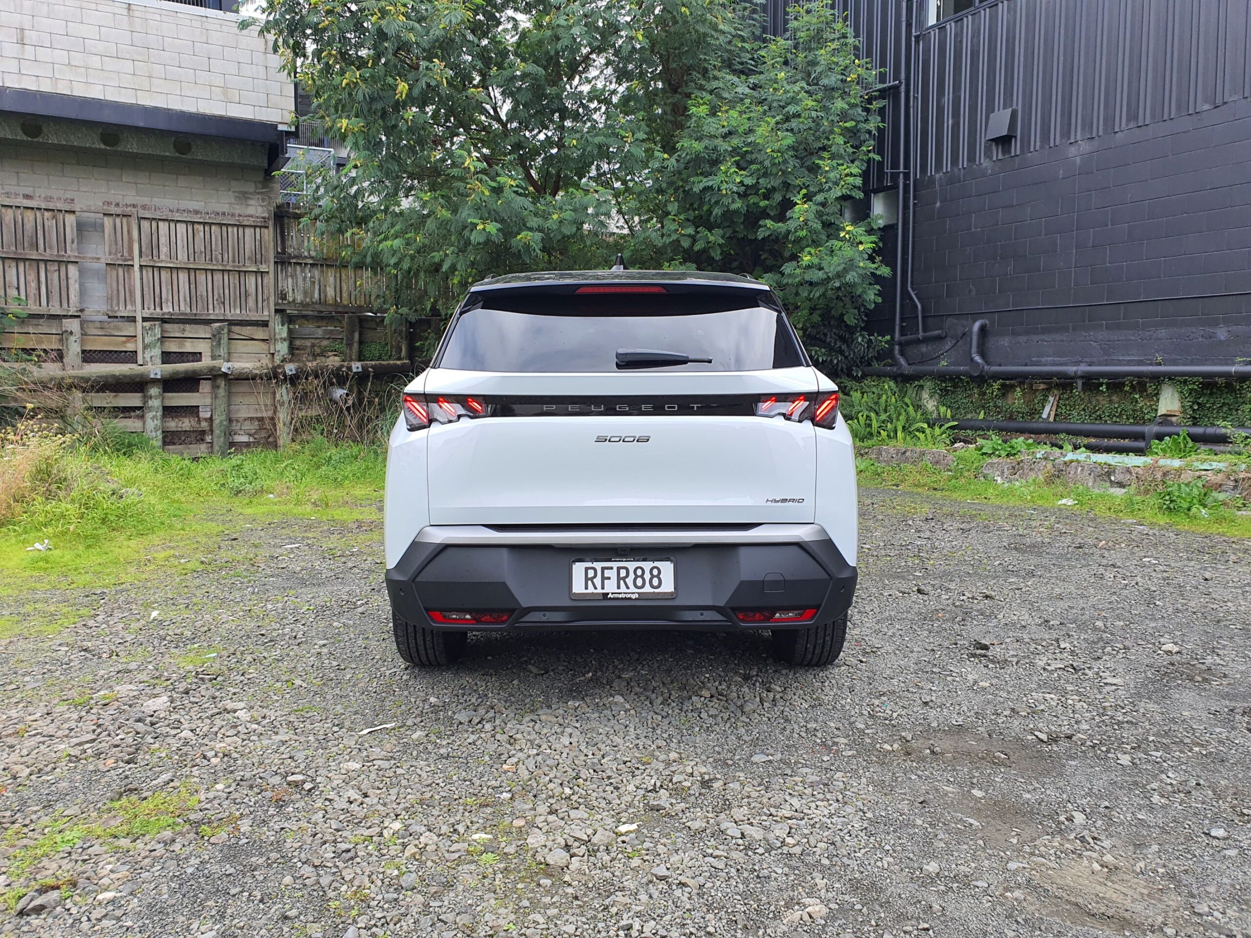 Rear on view of a 2025 Peugeot 5008 Hybrid in Okenite White with a Diamond Black roof.