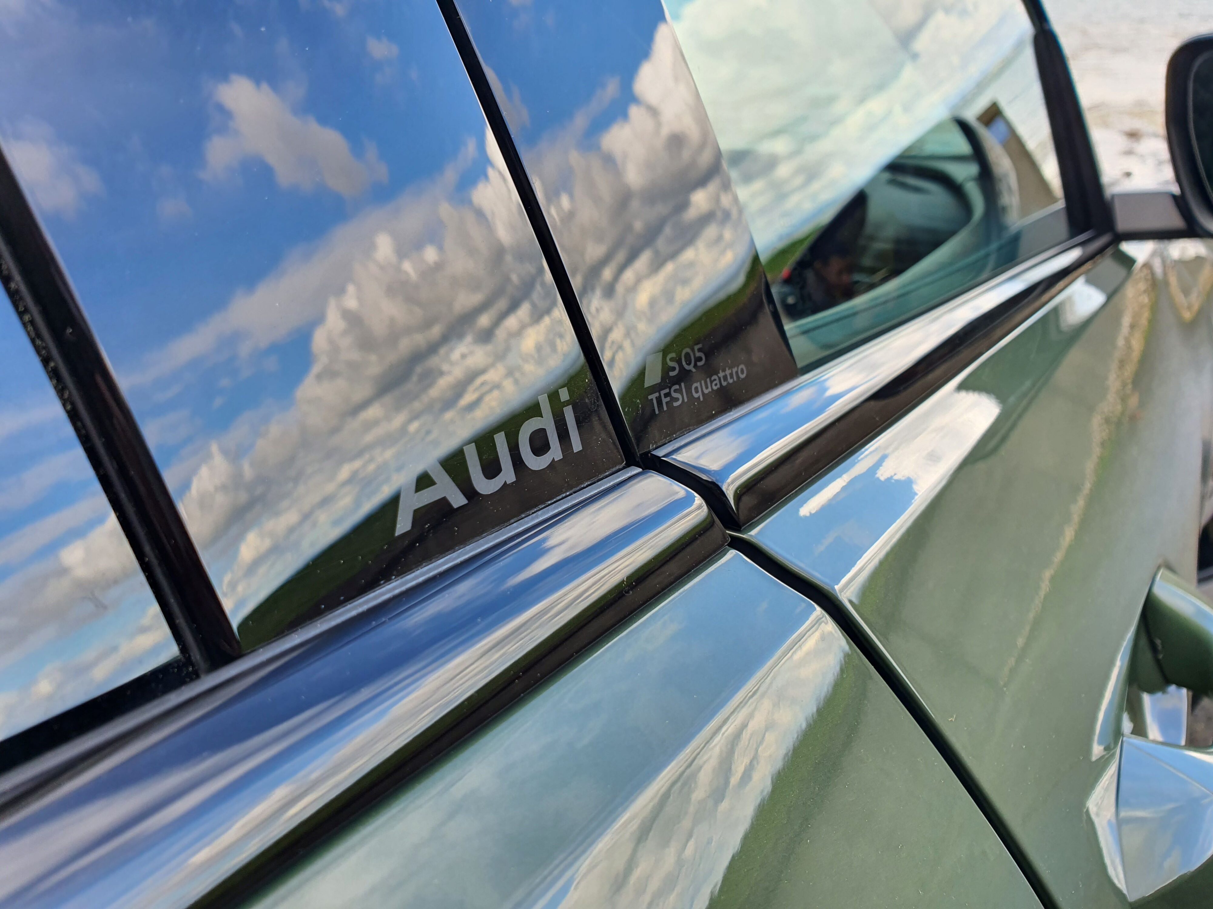 Photo of the 'Audi SQ5' badging on the door frames of a 2025 Audi SQ5 in District Green.