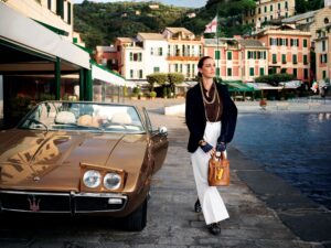 A photo of a model posing with a Maserati Ghibli Spyder as part of a collaboration with Acqua di Parma.