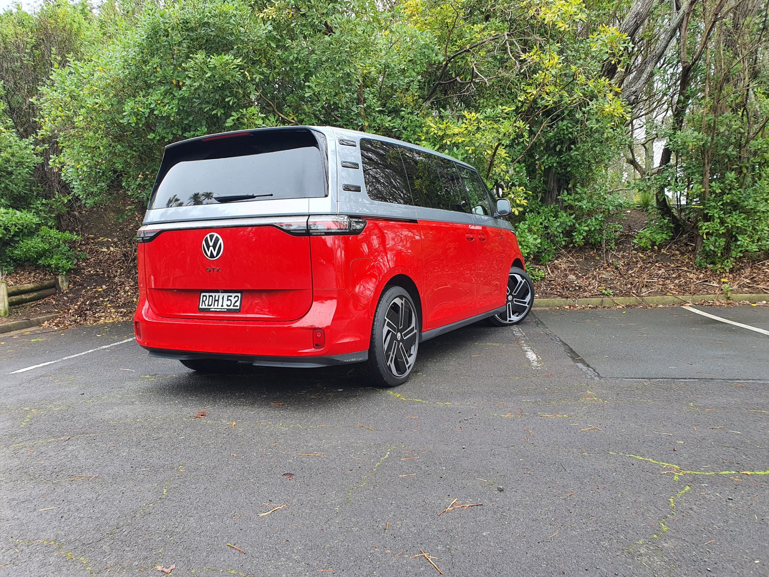 Rear three quarters of a 2025 Volkswagen ID.Buzz GTX in red and silver.