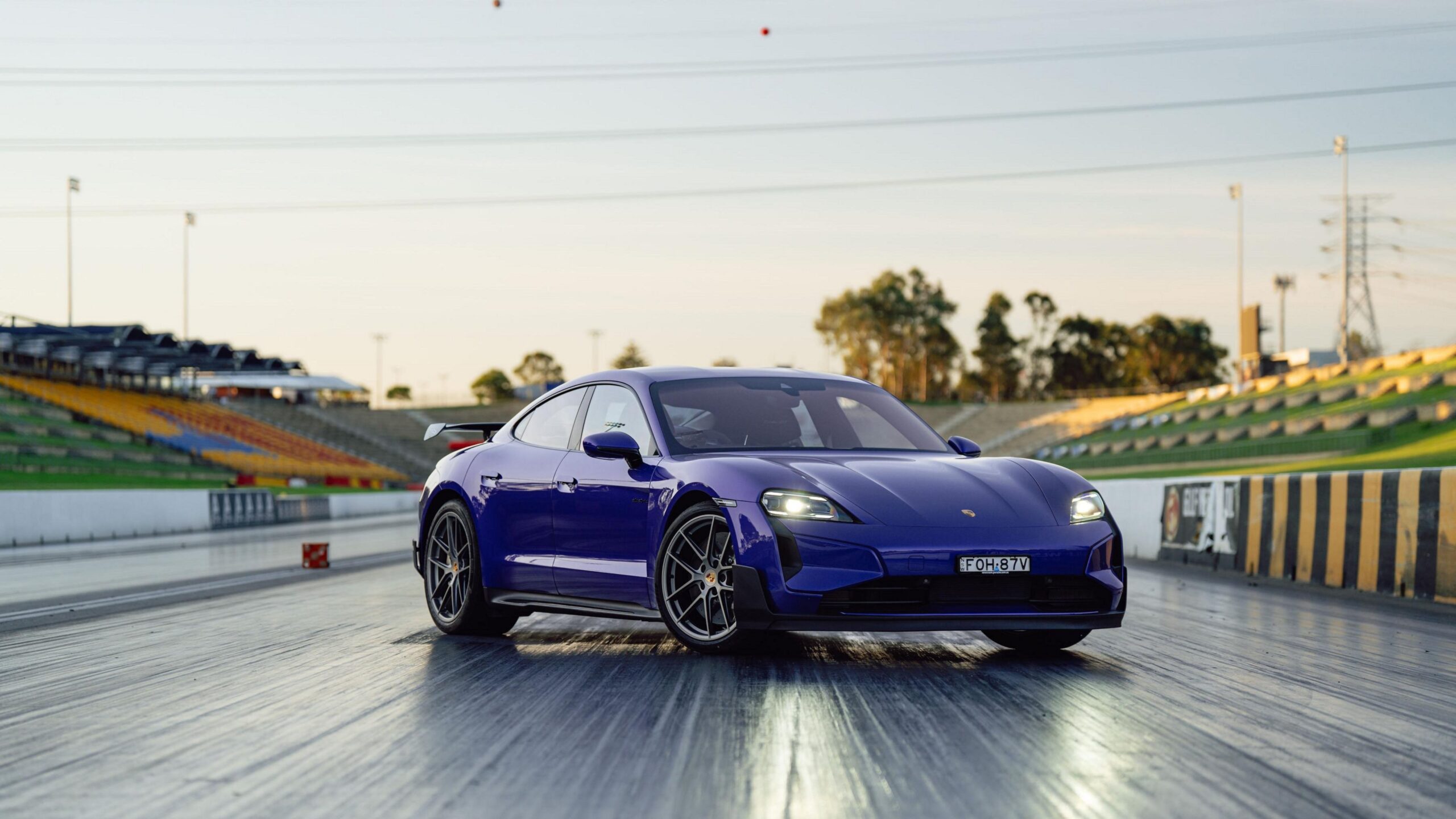 Front three quarters view of a purple Porsche Taycan Turbo GT at Sydney Dragway.
