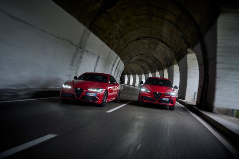 A photo of an Alfa Romeo Giulia Quadrifoglio and Stelvio Quadrifoglio side by side in a tunnel, both in red.