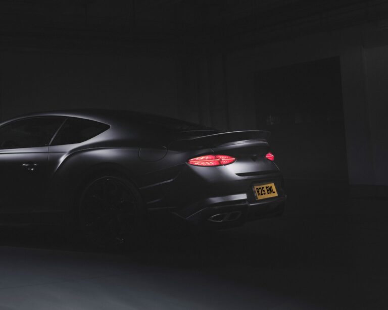 Teaser image of a matte black Bentley Continental Supersports.