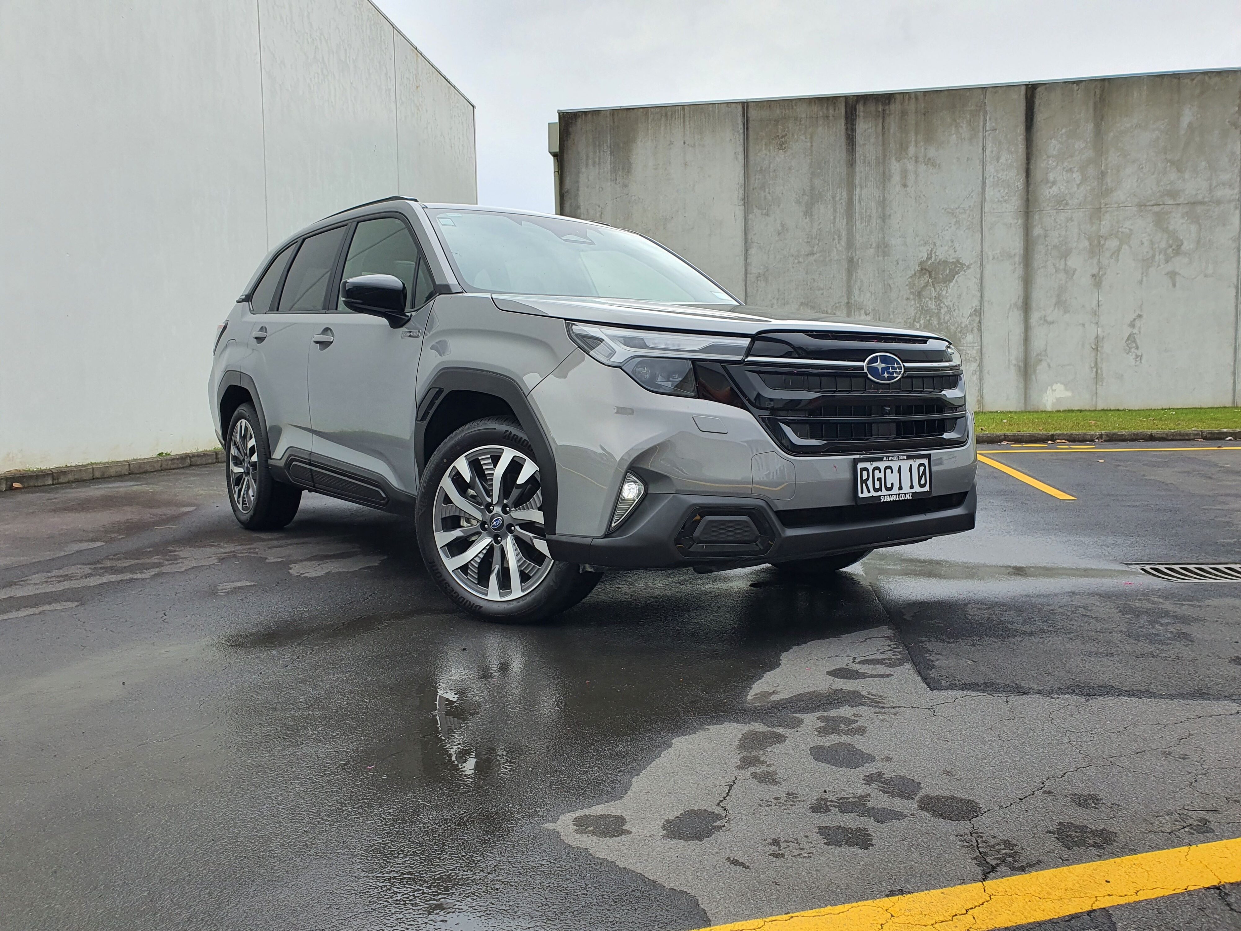 Front three quarters view of a 2025 Subaru Forester AWD Touring Hybrid in River Rock Pearl.