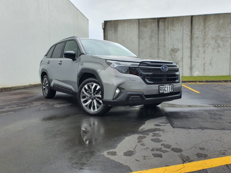 Front three quarters view of a 2025 Subaru Forester AWD Touring Hybrid in River Rock Pearl.