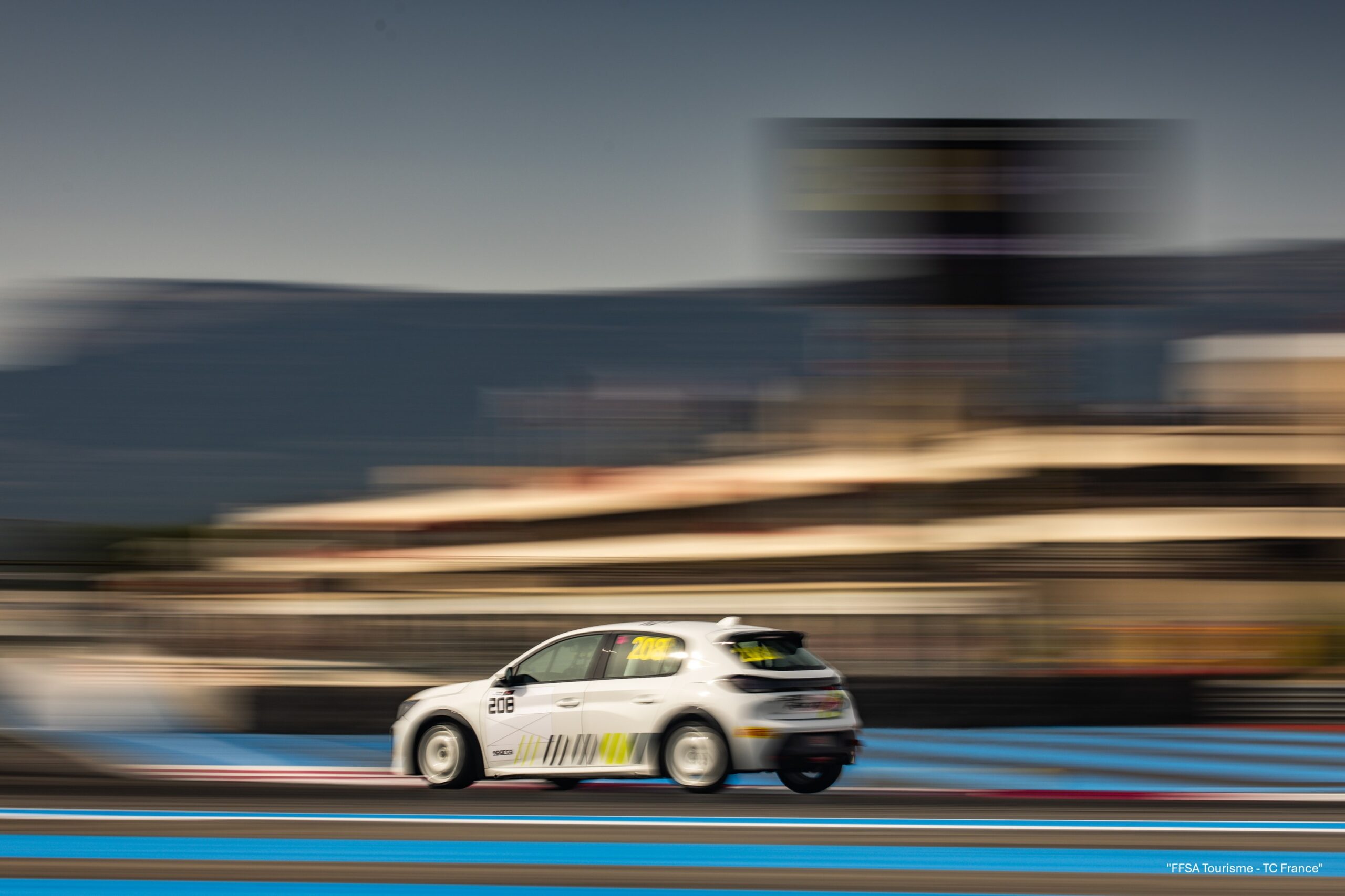 A photo of a Peugeot 208 Racing TC6 on track during testing.