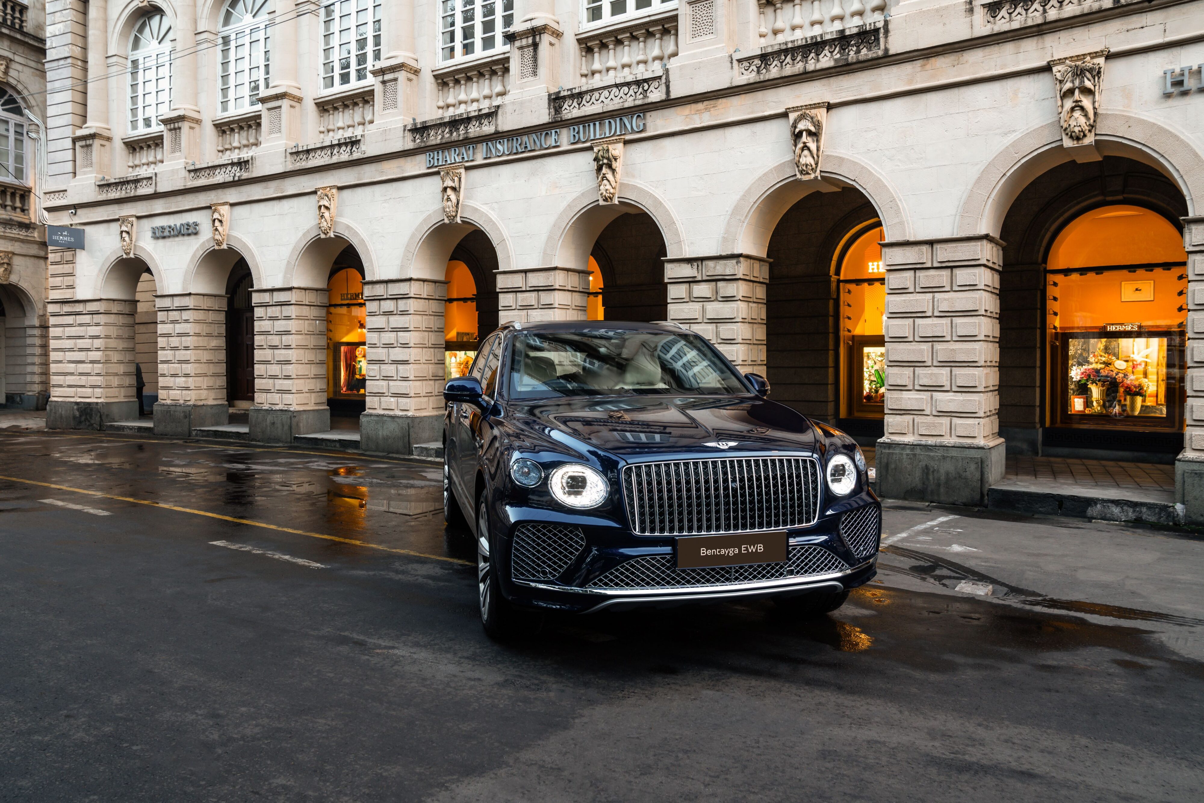 A photo of a Bentley Bentayga EWB outside a Hermes boutique in India.