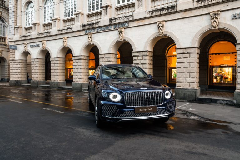 A photo of a Bentley Bentayga EWB outside a Hermes boutique in India.