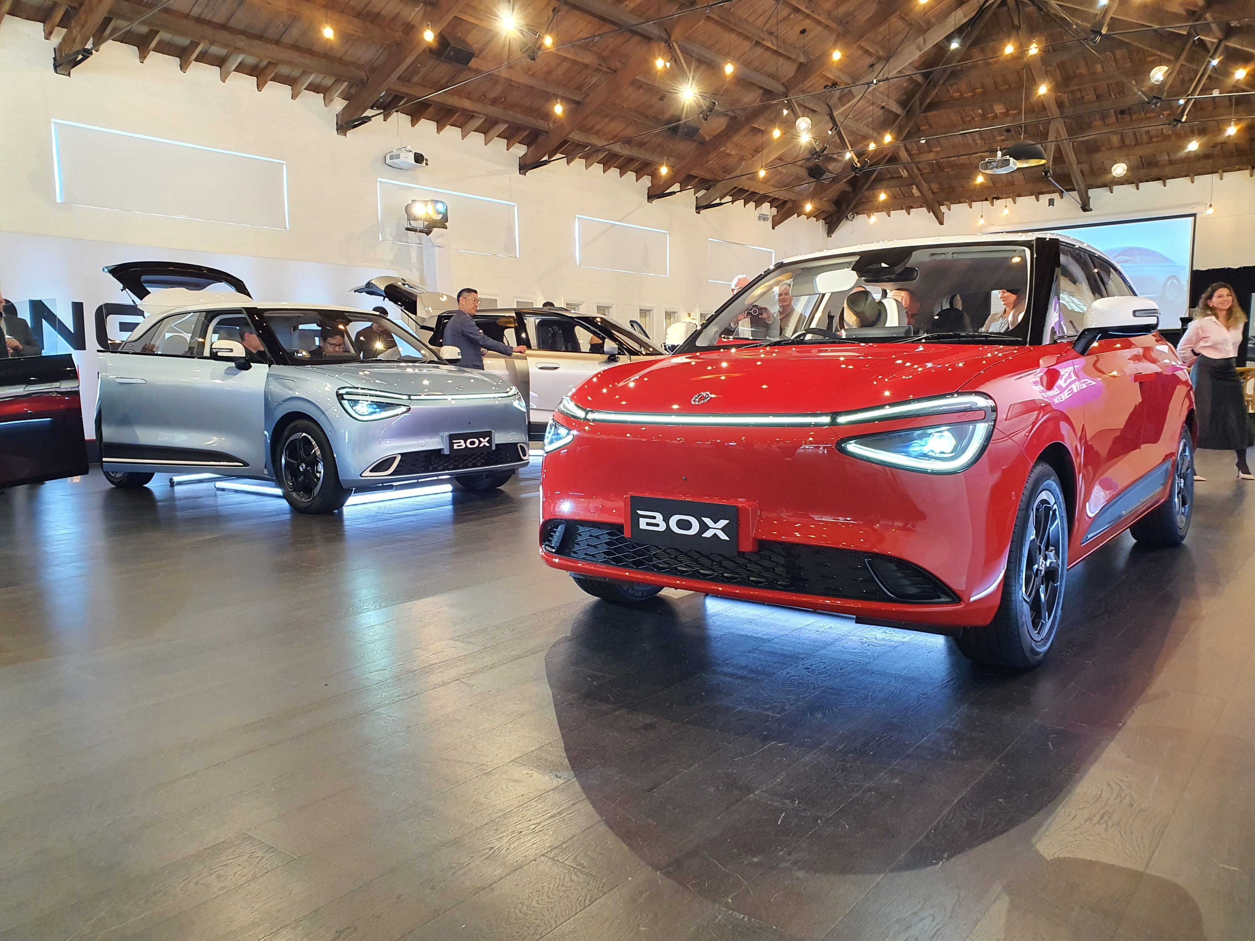 A photo of two Dongfeng Box EVs in red and blue at the 2025 New Zealand launch of the Dongfeng Motors brand and Box EV.