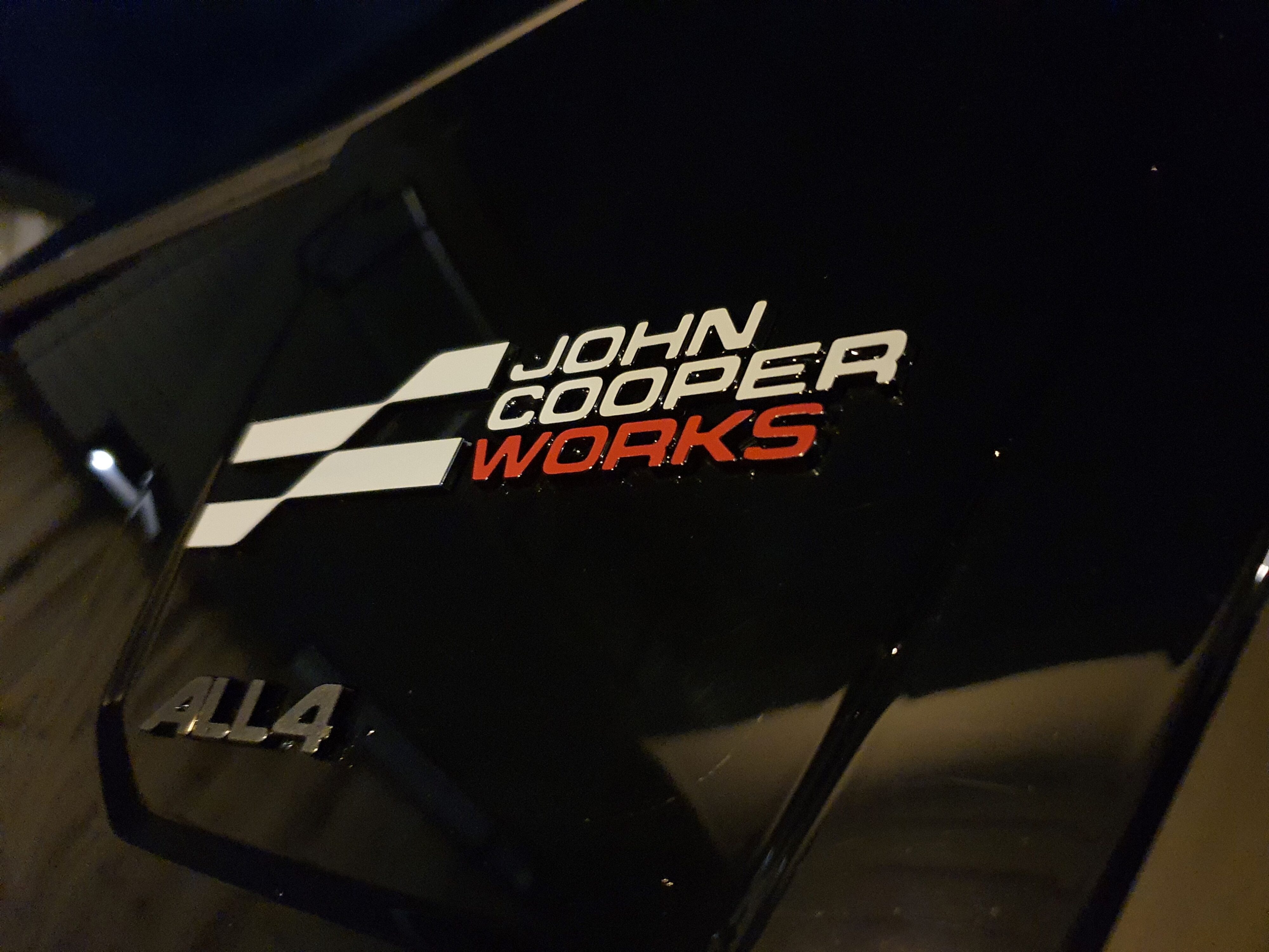 View of the rear three quarters John Cooper Works badge on a 2025 Mini Countryman John Cooper Works in Red with a Black roof.
