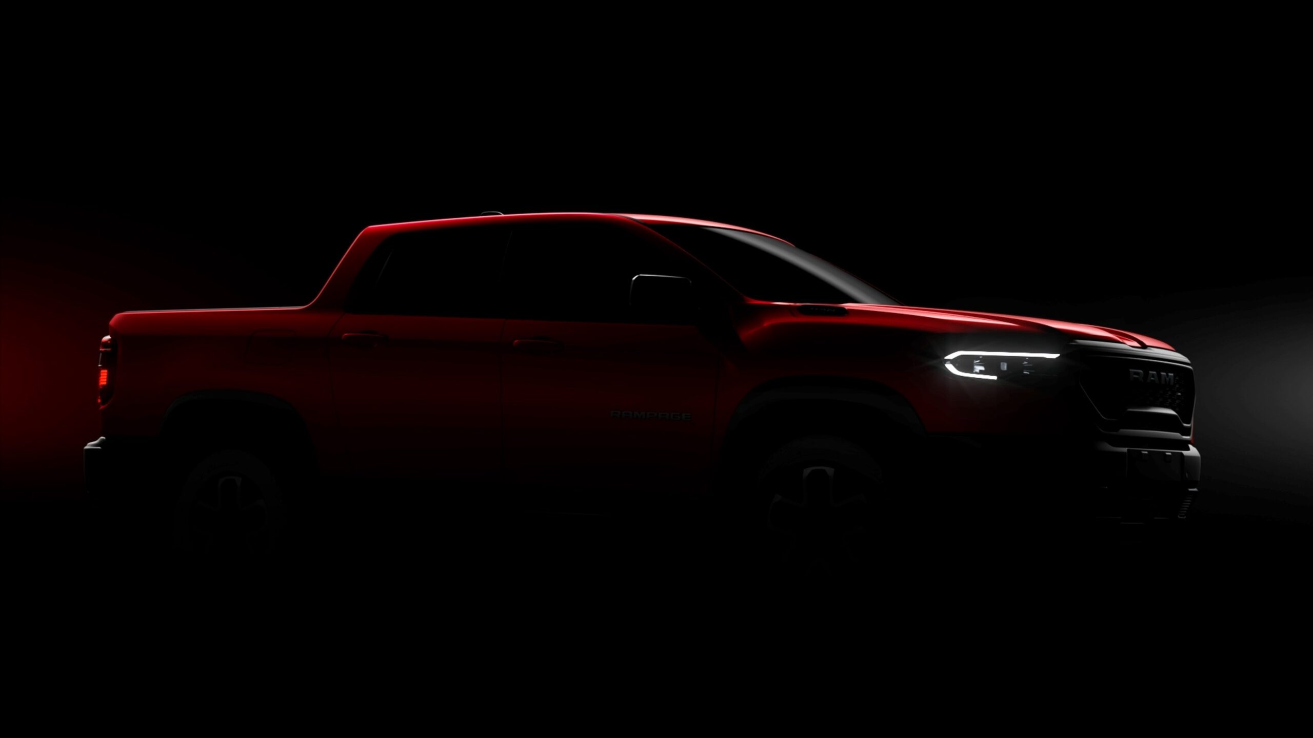 Teaser image of the front three quarters view of a RAM Rampage pickup truck.