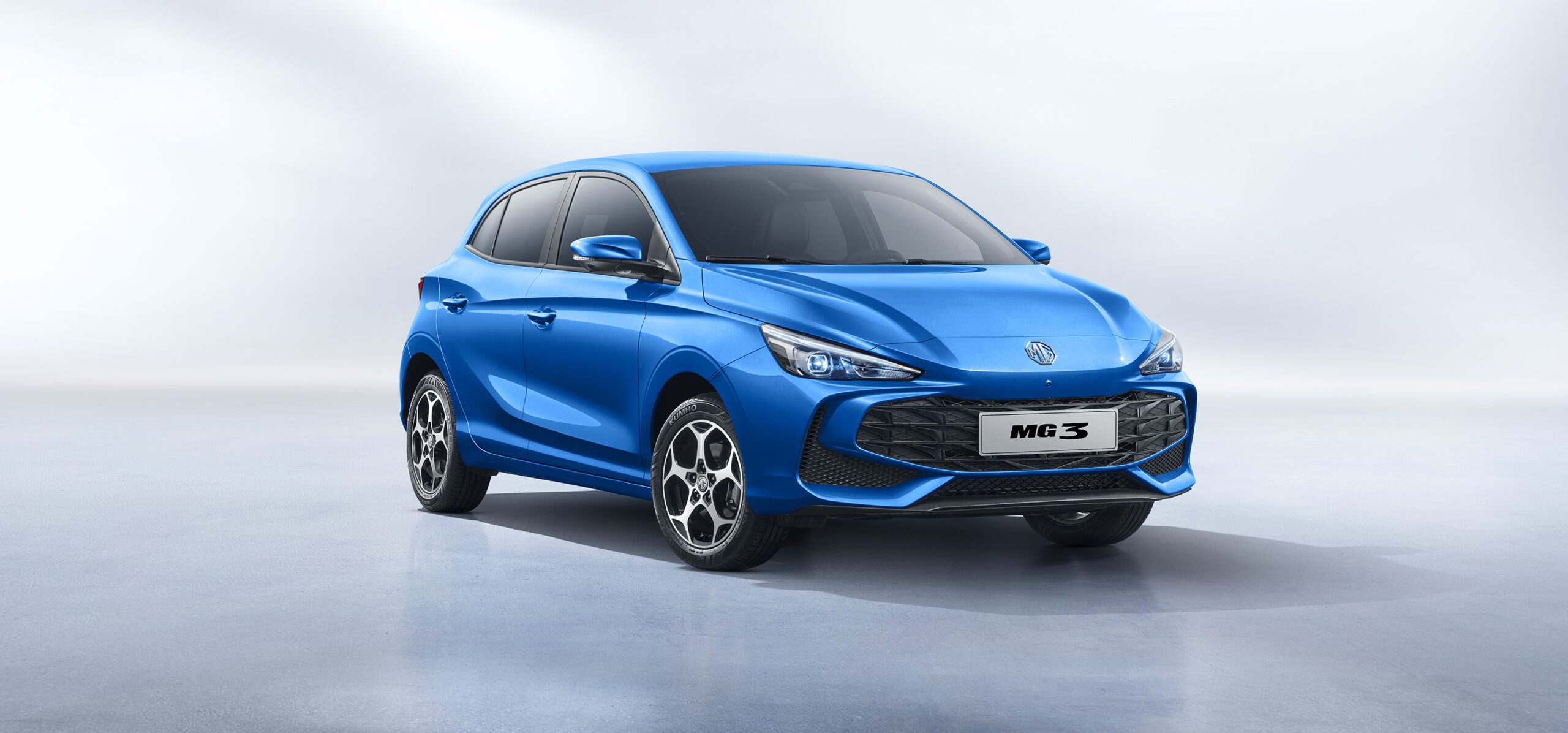 Front three quarters view of a blue MG3 Hybrid+ on a plain background.