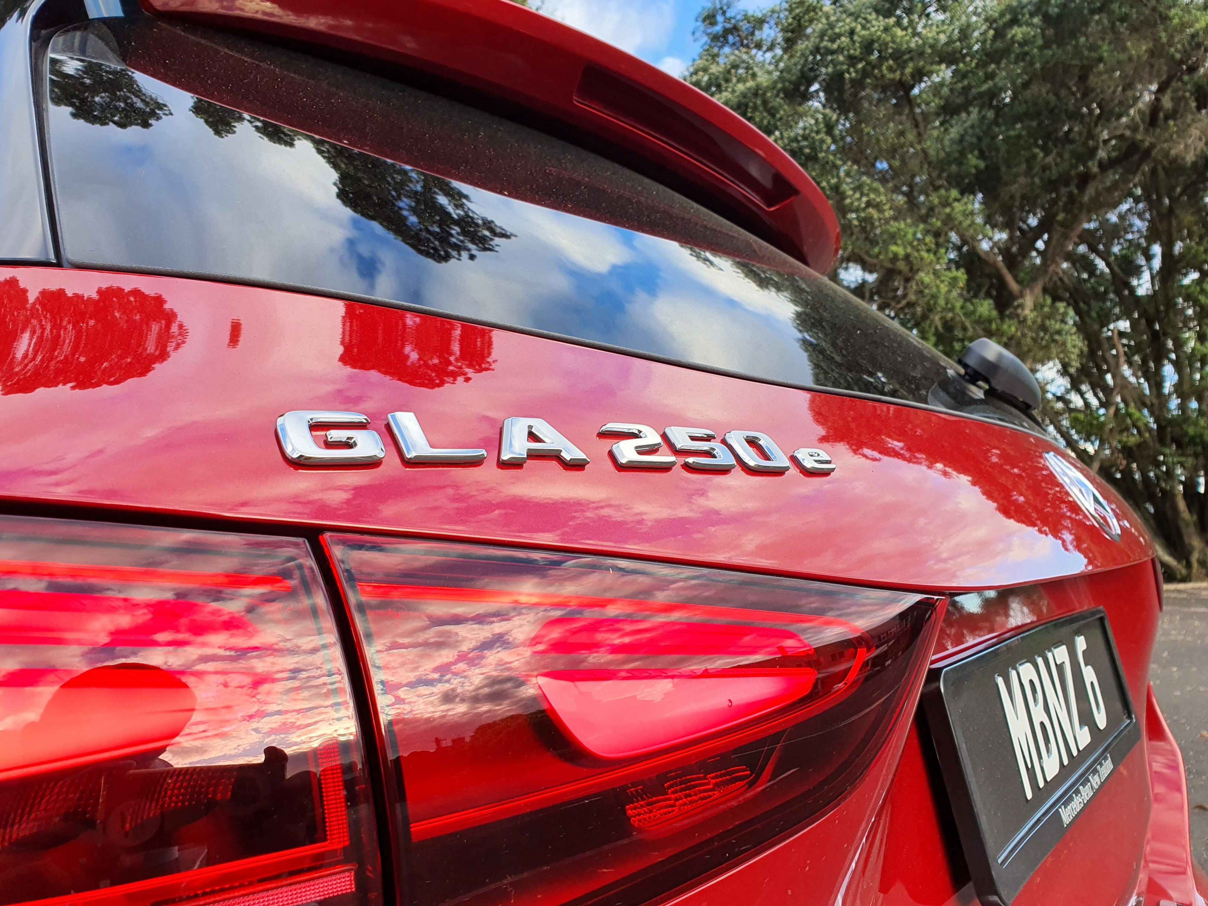 Close up of the GLA250e badge on the rear of a 2025 Mercedes-Benz GLA250e in Patagonia Red Metallic.