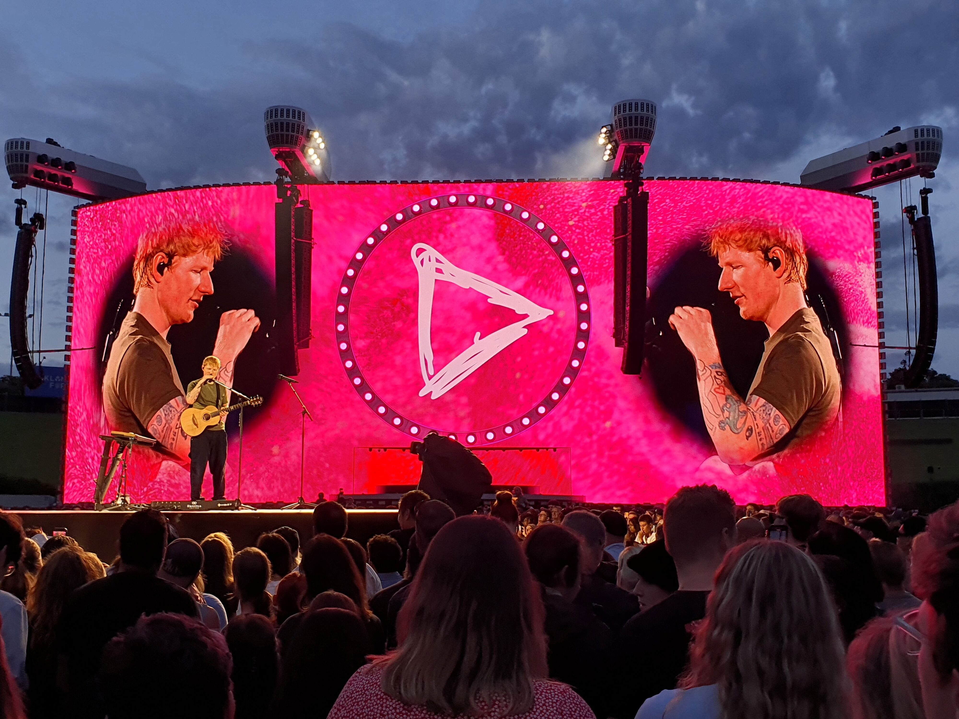 Photo of Ed Sheeran performing on stage during the Loop Tour 2026 at Go Media Stadium in Auckland, New Zealand.