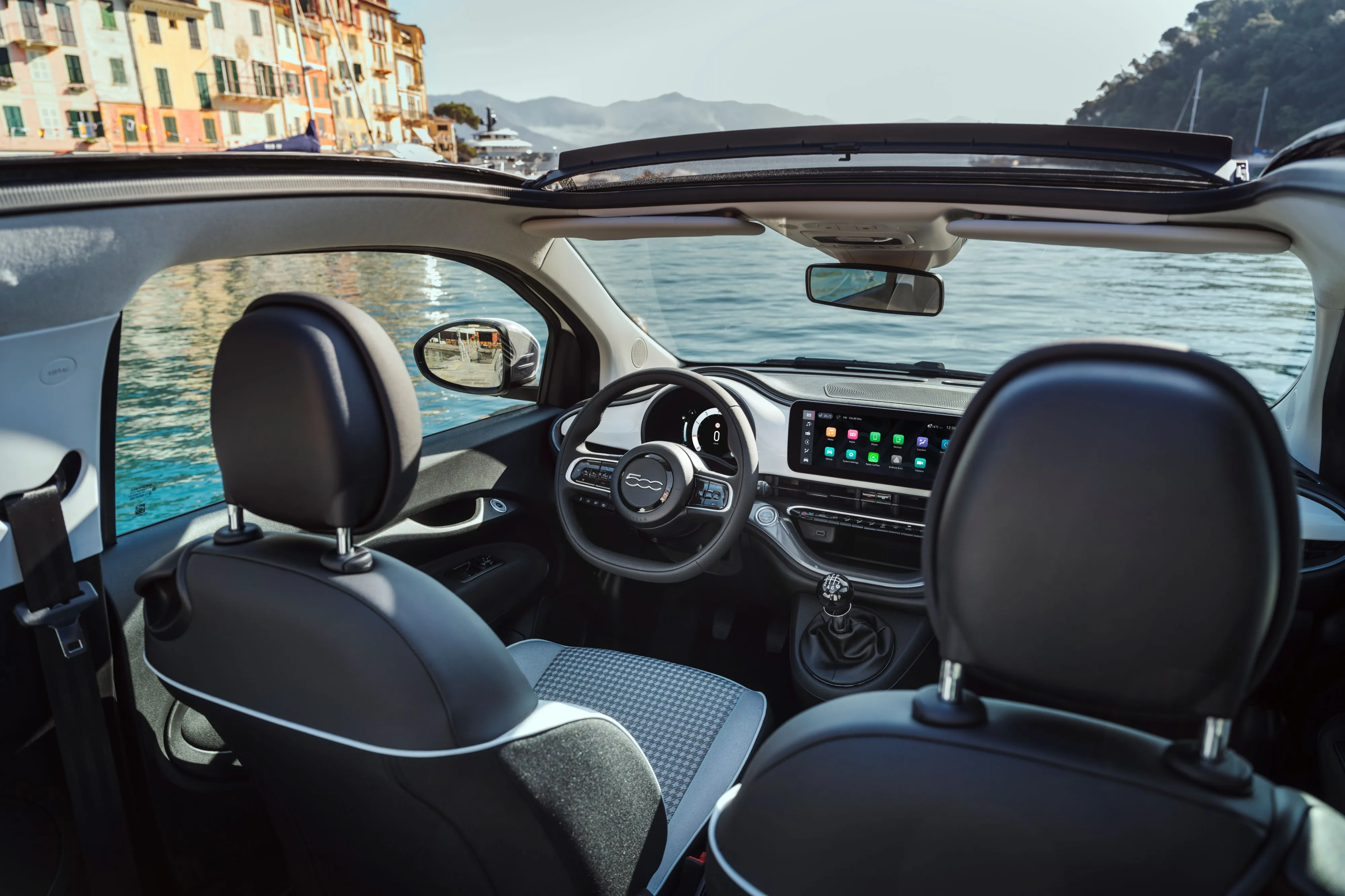 Interior view of a Fiat 500 Dolcevita Special Series with the ocean visible through the windscreen.