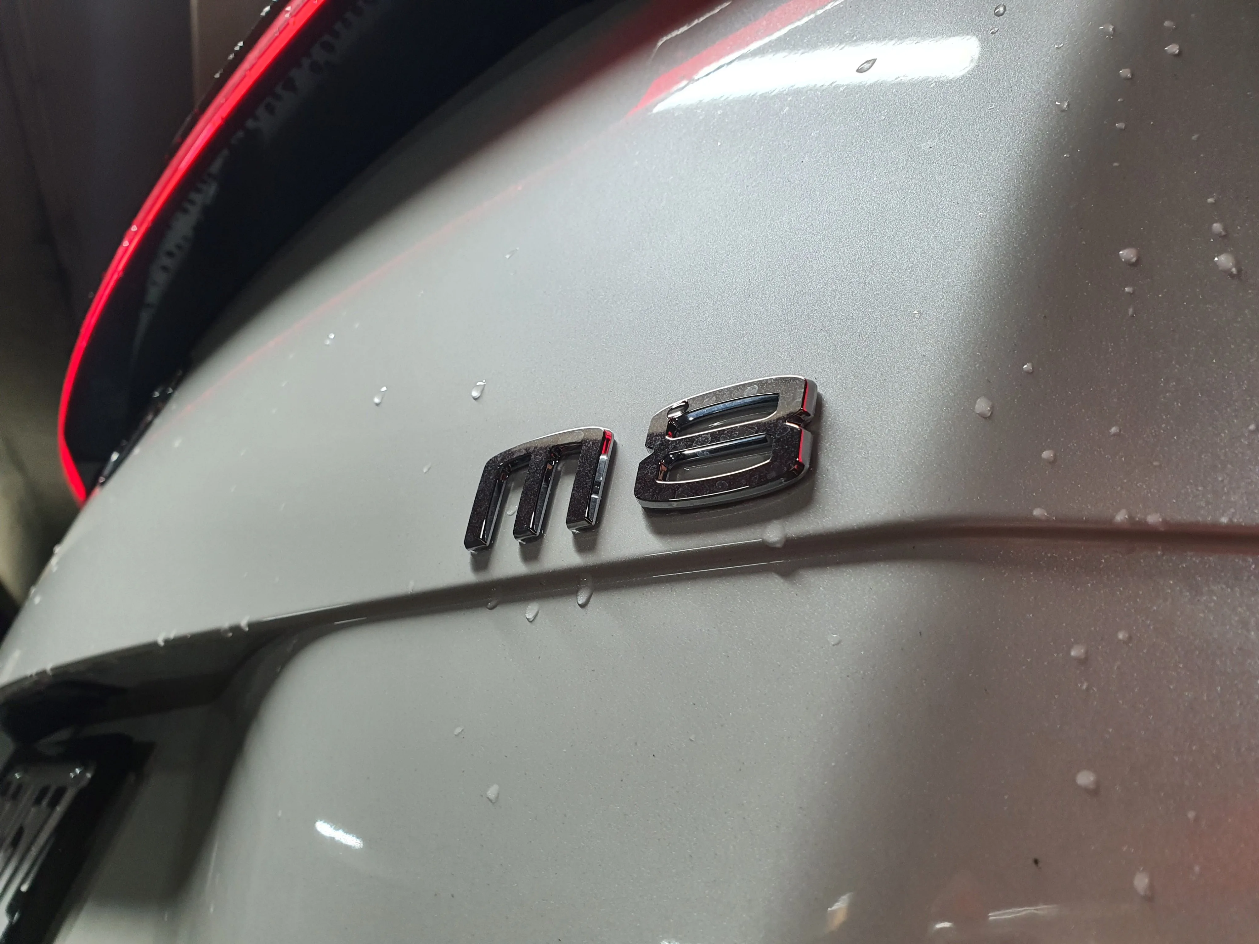 Close up of the M8 badge on the rear of a 2026 GAC M8 Master in white.