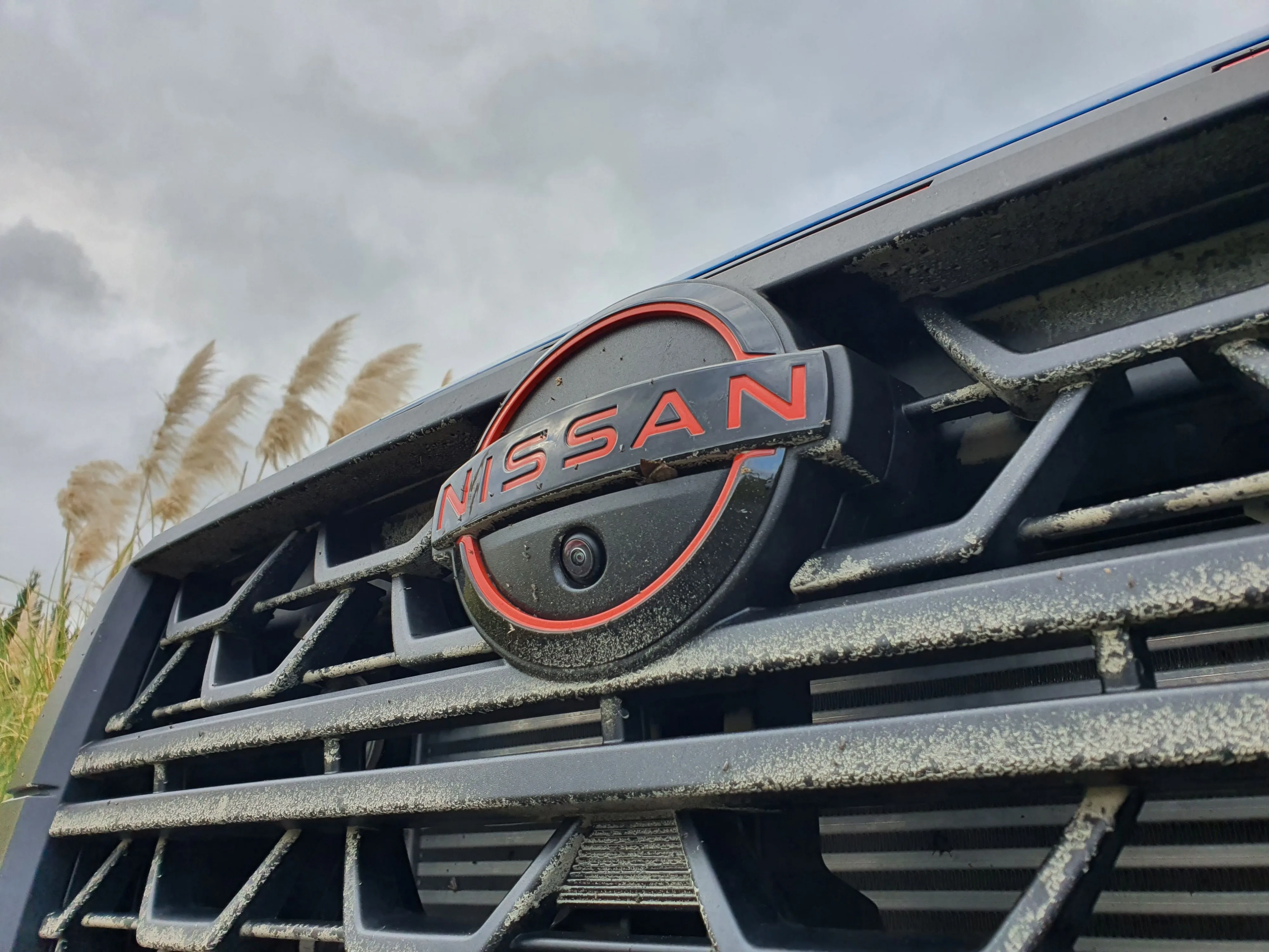Low angle view of the Nissan badge on the nose of a 2026 Navara Pro-4X.