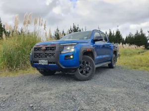 Low angle front three quarters view of a 2026 Nissan Navara Pro-4X in Horizon Blue.