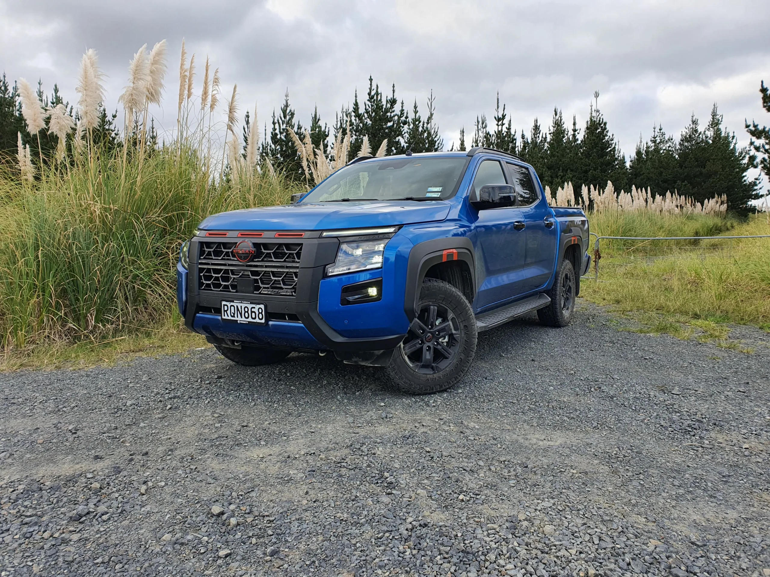 Front three quarters view of a 2026 Nissan Navara Pro-4X in Horizon Blue.