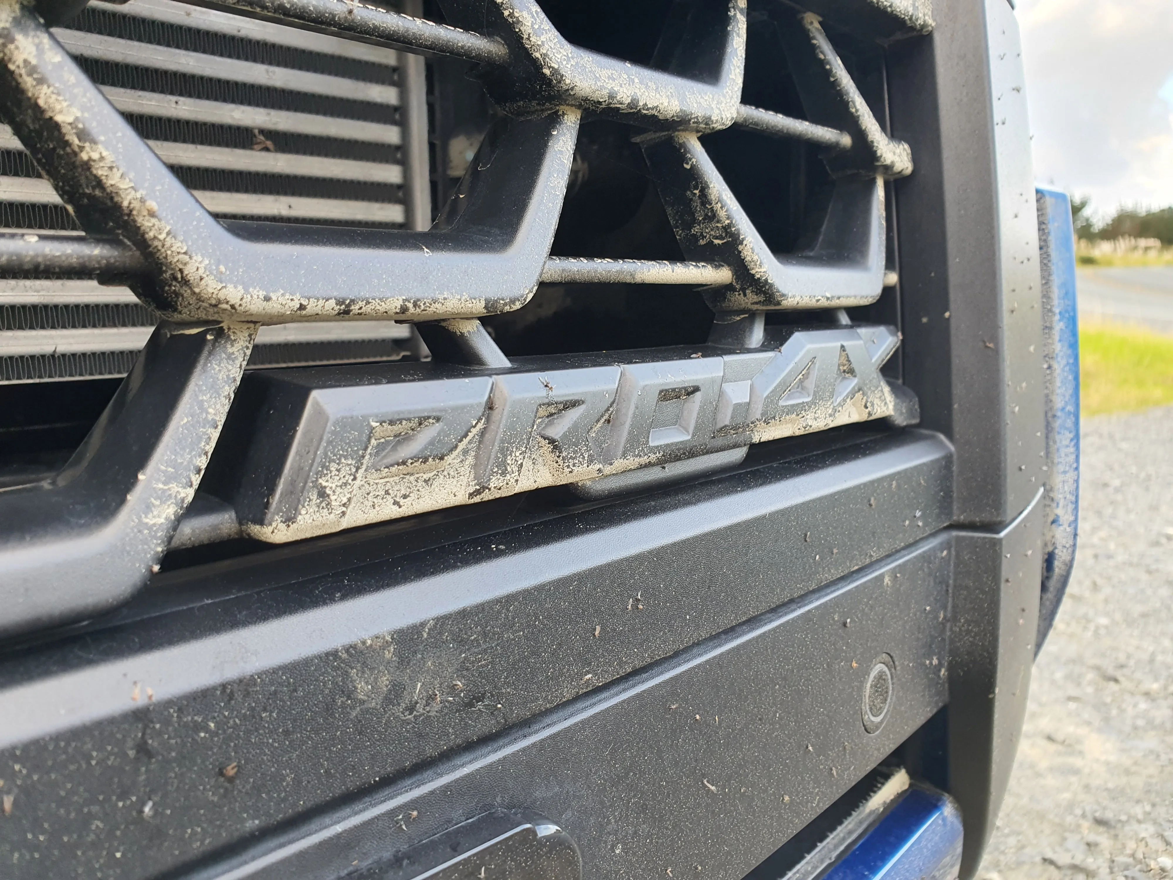 Close up of the Pro-4X badge on the front grille of a 2026 Nissan Navara Pro-4X.