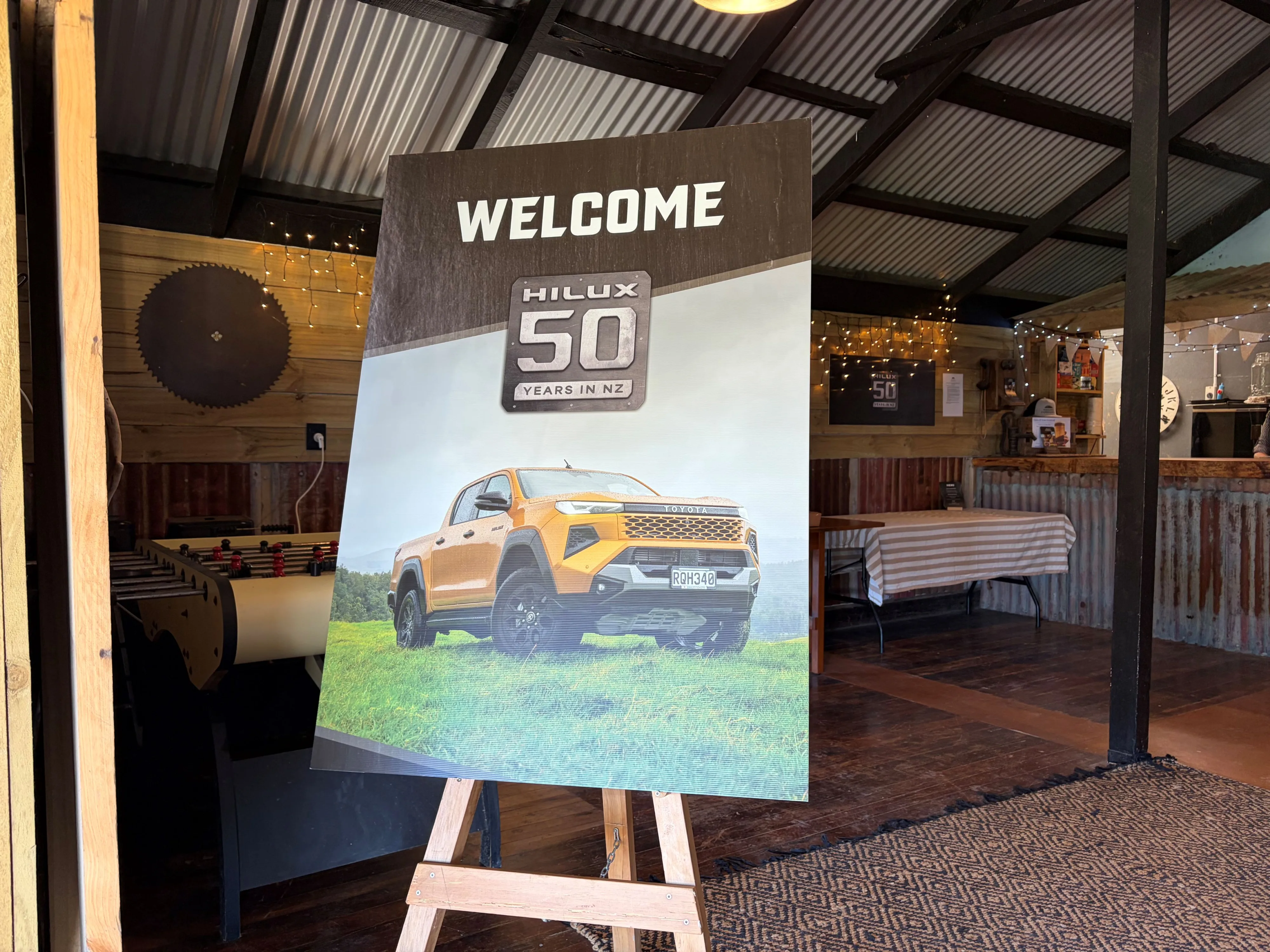 Photograph of the promotional poster for '50 years of Hilux in NZ' at the New Zealand launch of the 2026 ninth-generation Toyota Hilux, taken at Heights Experience in Manawatu, New Zealand.