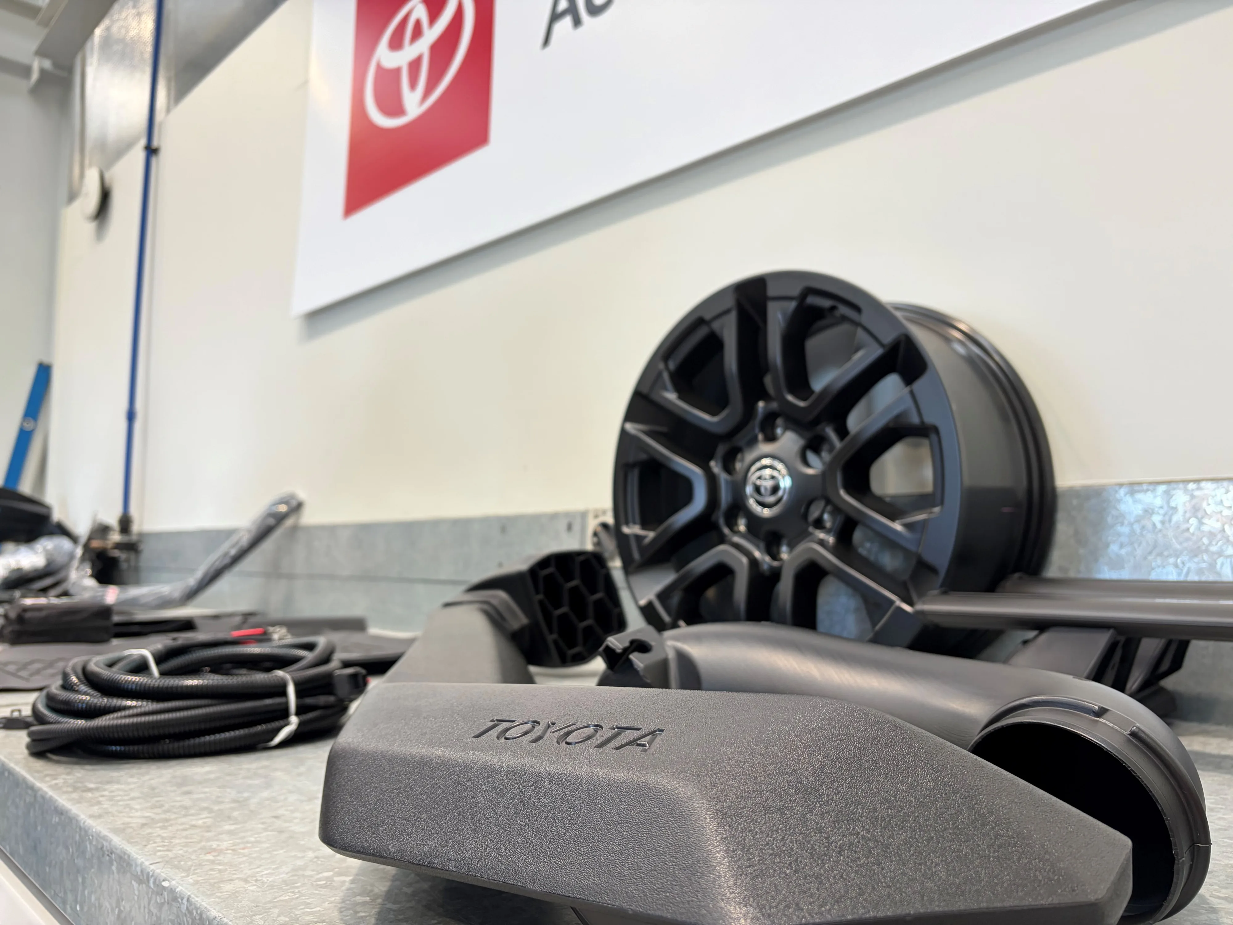 Close up of a snorkel and wheel along with other Hilux accessories, taken on the 2026 New Zealand launch of the ninth-generation Toyota Hilux.