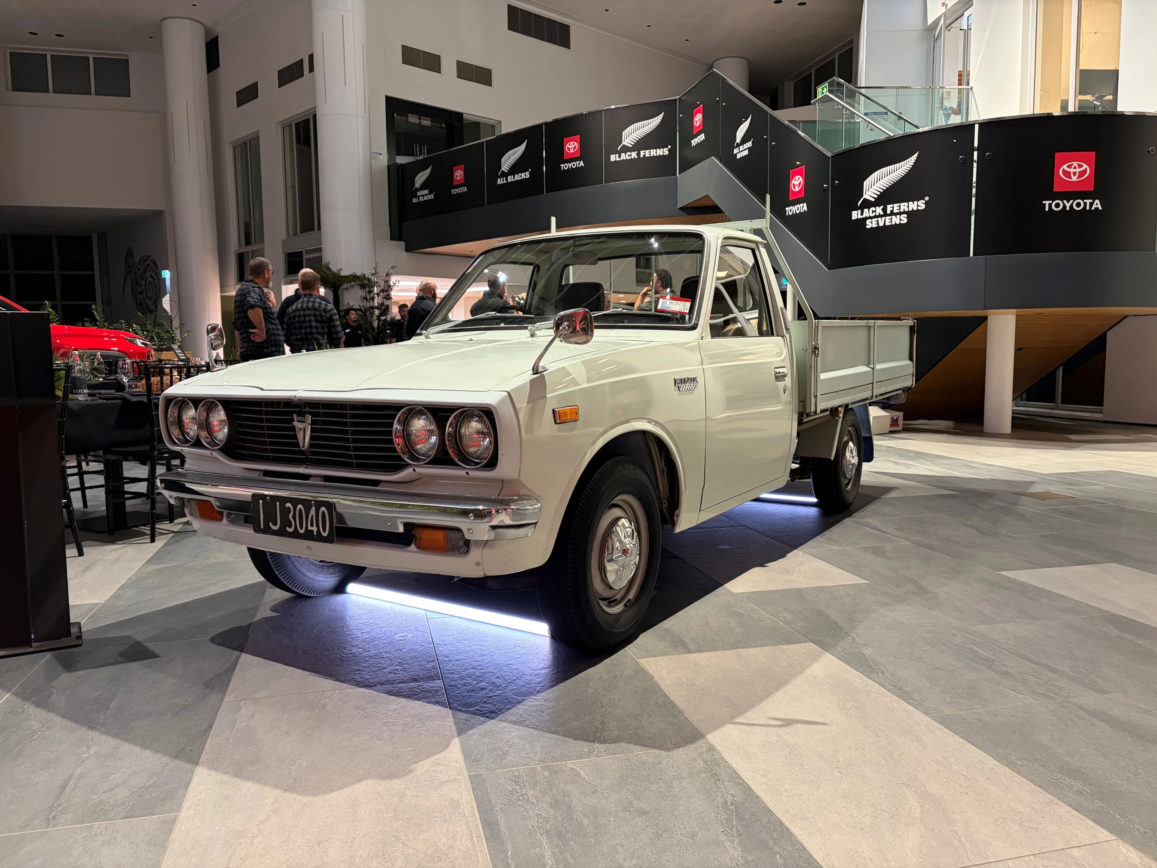 Front three quarters view of a 1977 Toyota Hilux in light blue at Toyota New Zealand's headquarters in Palmerston North, Manawatu, New Zealand.