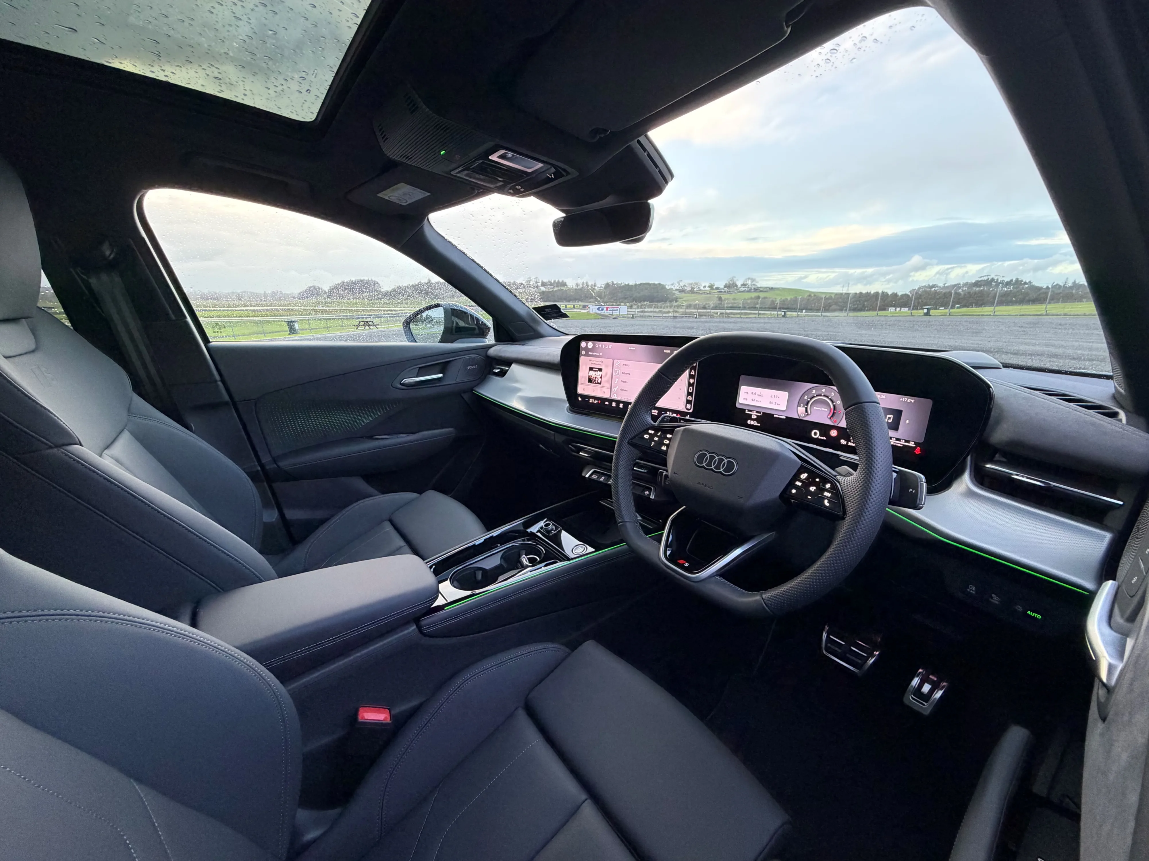 Interior view of a 2026 Audi Q3 195kW S-Line quattro in Sage Green, photographed at sunset.