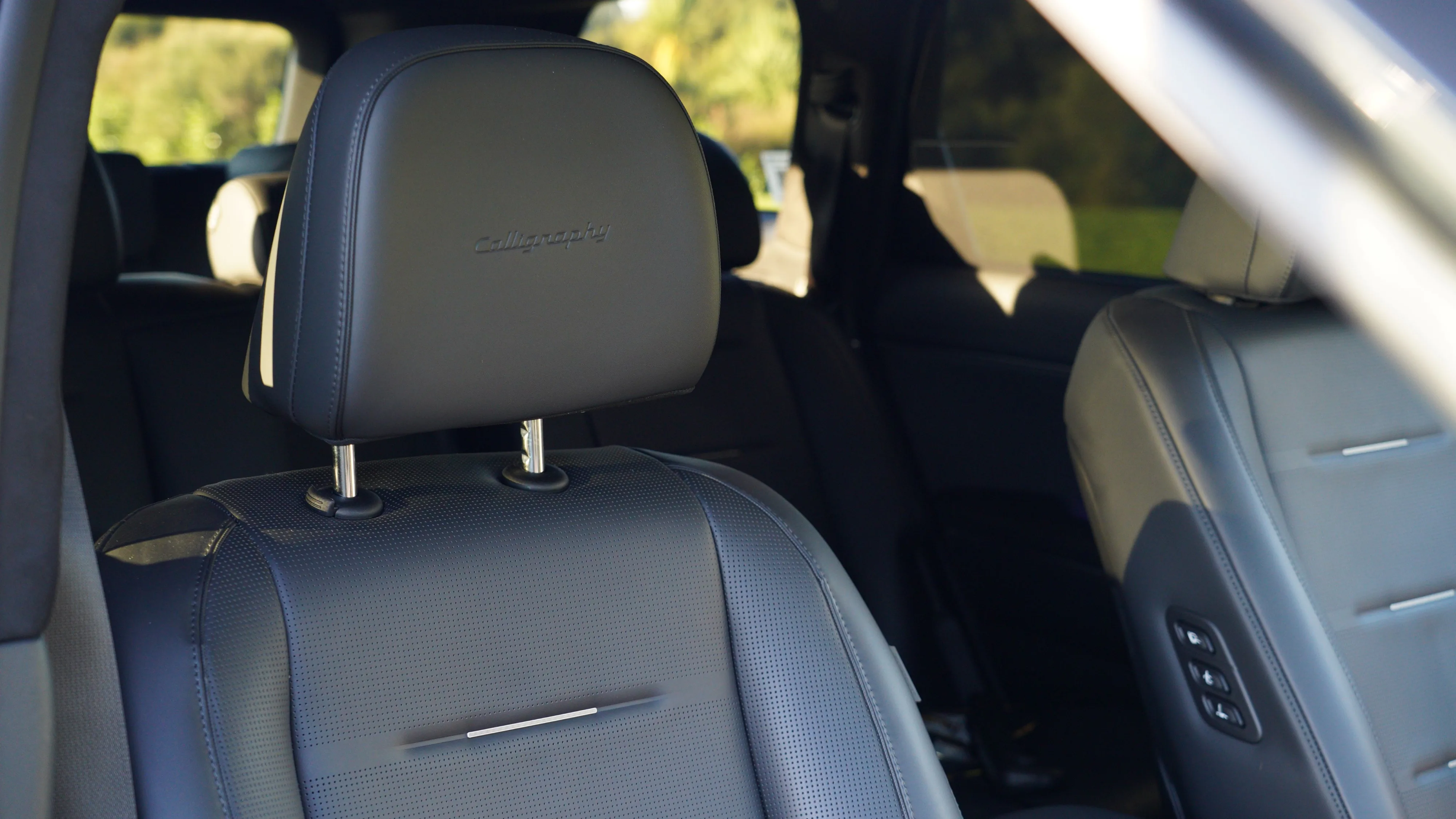 Close up of the embossed 'Calligraphy' logo on the interior of a 2026 Hyundai Palisade Calligraphy Hybrid with the Obsidian Black Nappa Leather interior.