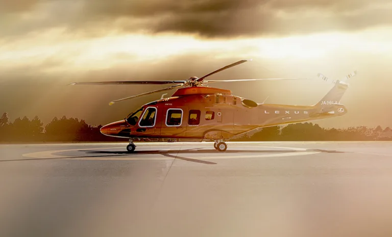 A photo of the 'Lexus Flight' helicopter on a helipad.