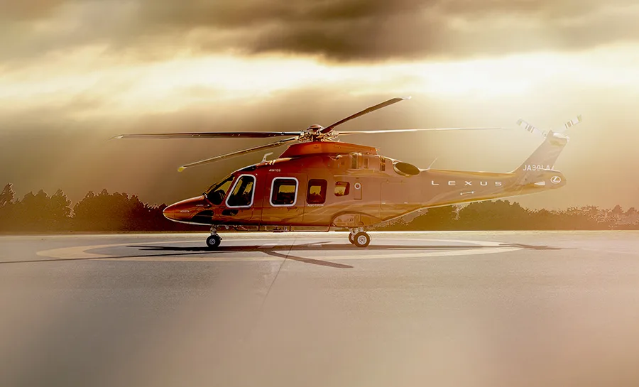 A photo of the 'Lexus Flight' helicopter on a helipad.
