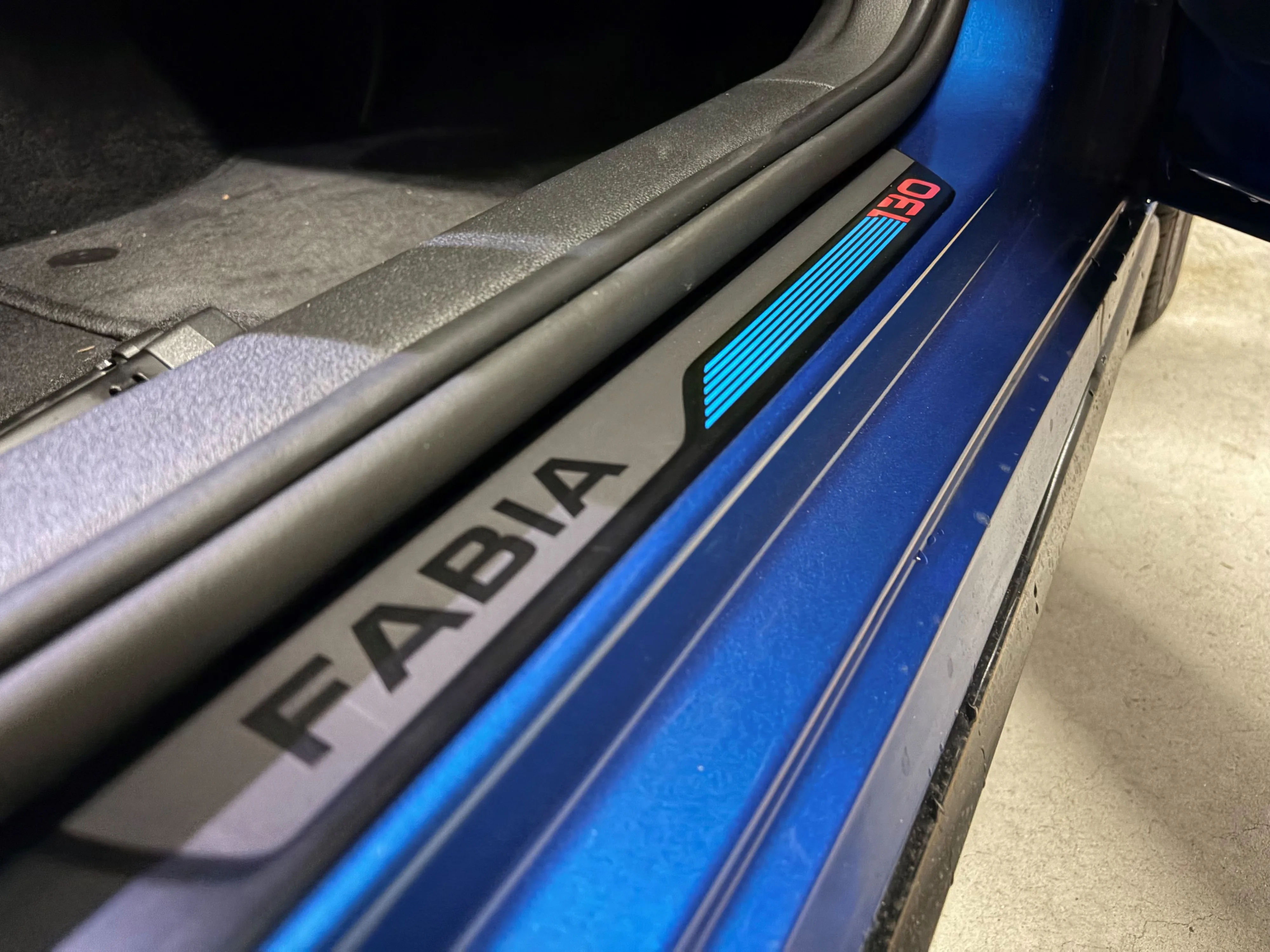 Close-up of the front scuff plates labelled Fabia 130 on the inside of a 2026 Skoda Fabia 130.