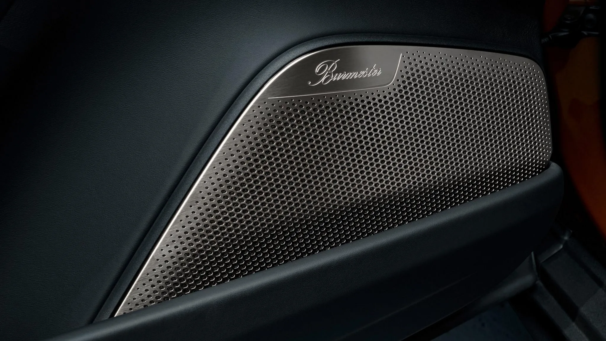 Photo of the Burmester branded speakers on the door of a Porsche Macan Electric.