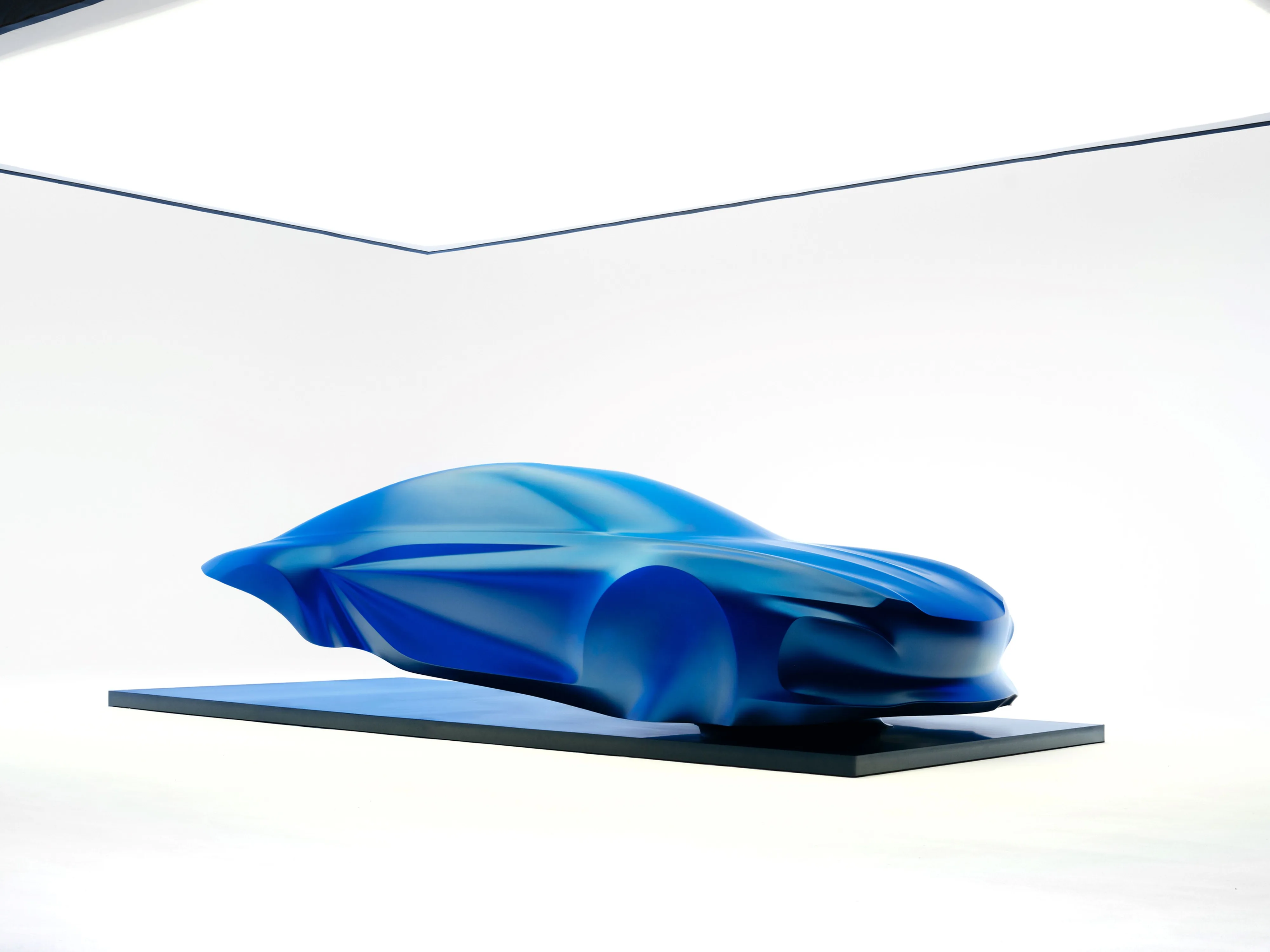 Front three quarters view of a sculpture of the third generation Alpine A110.